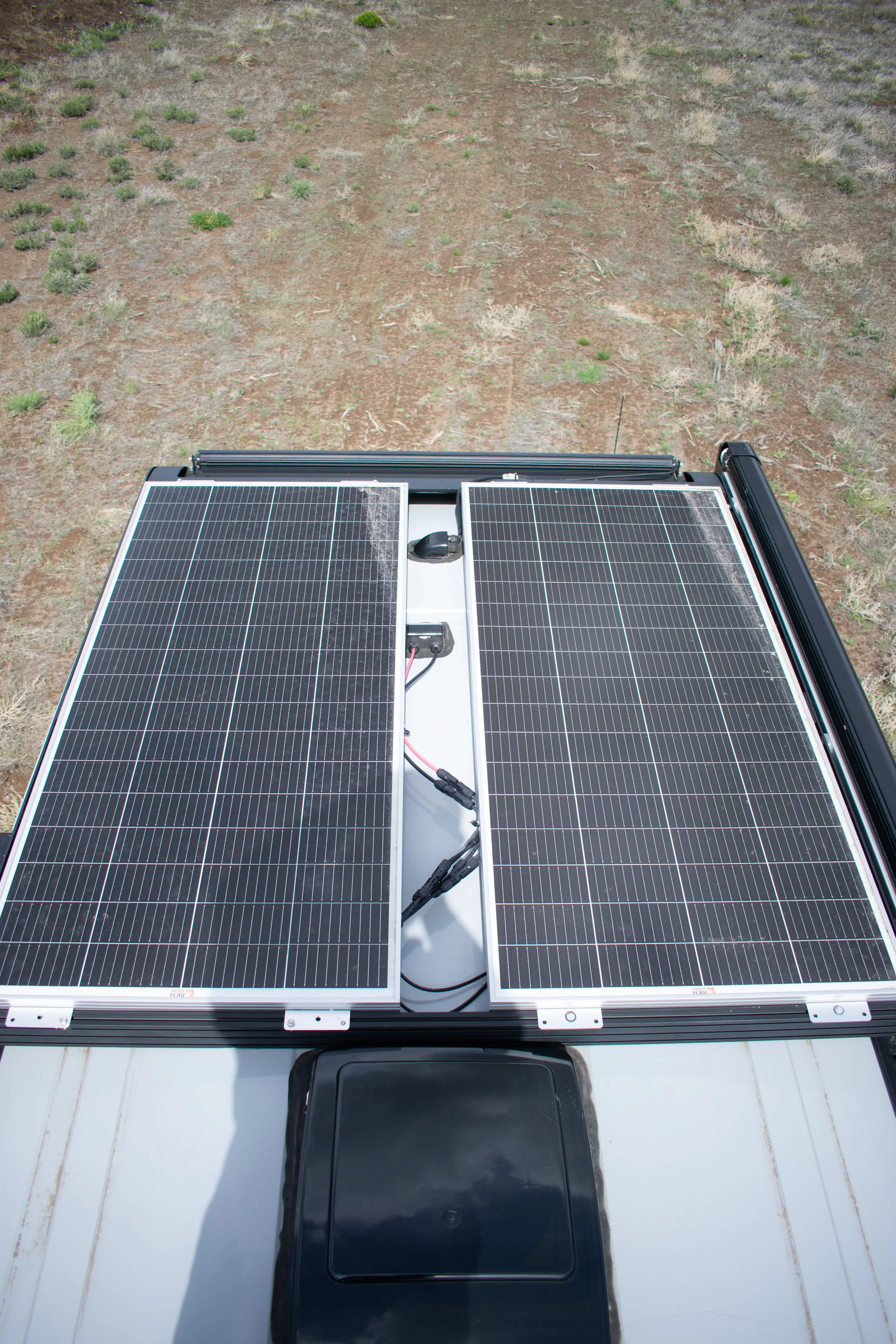 Ford Transit van with solar panels and roof rack – off-grid camper conversion by Oxbow Vans