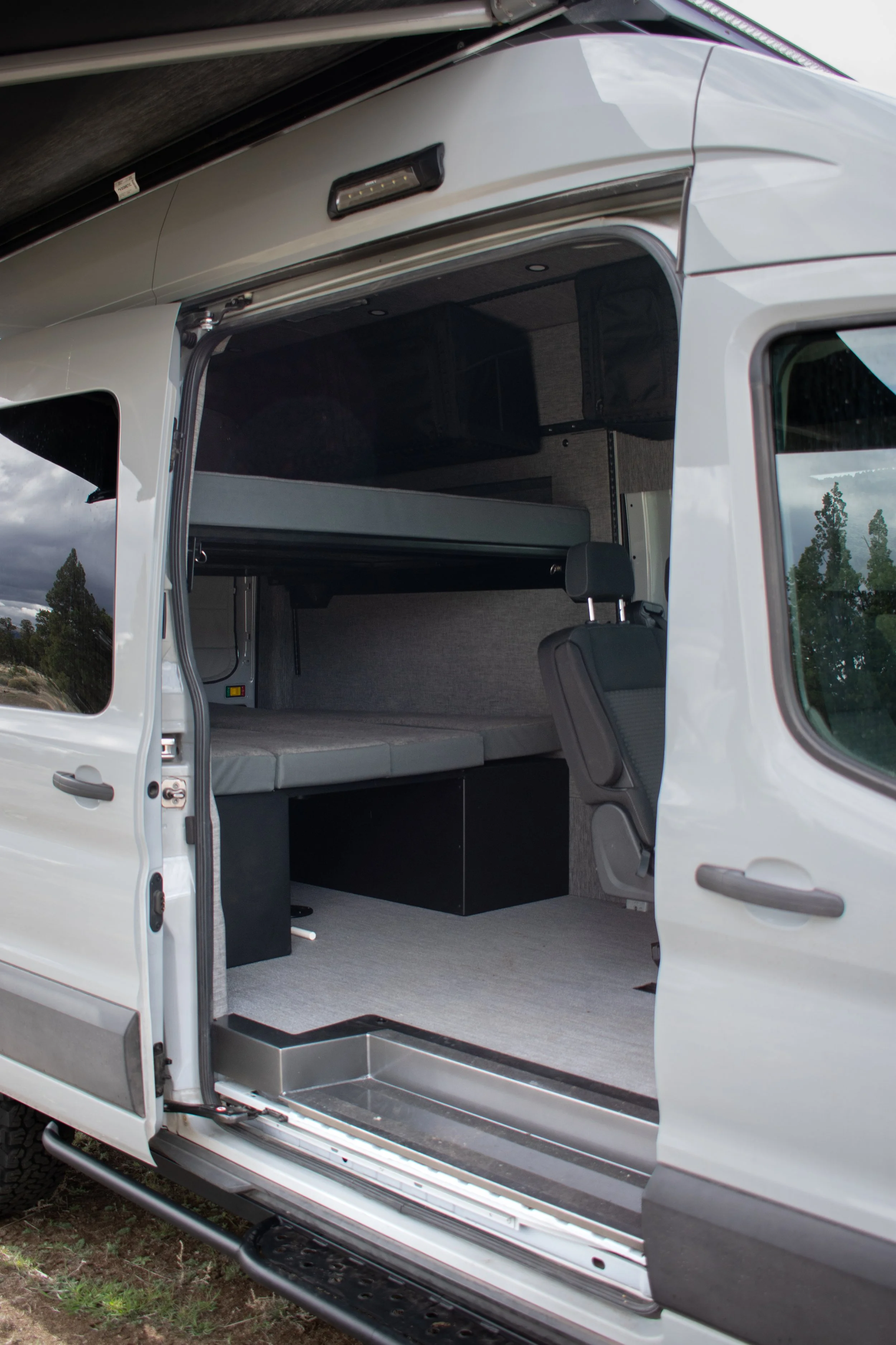 Adventure van interior with bunk beds and seating – Oxbow Vans build