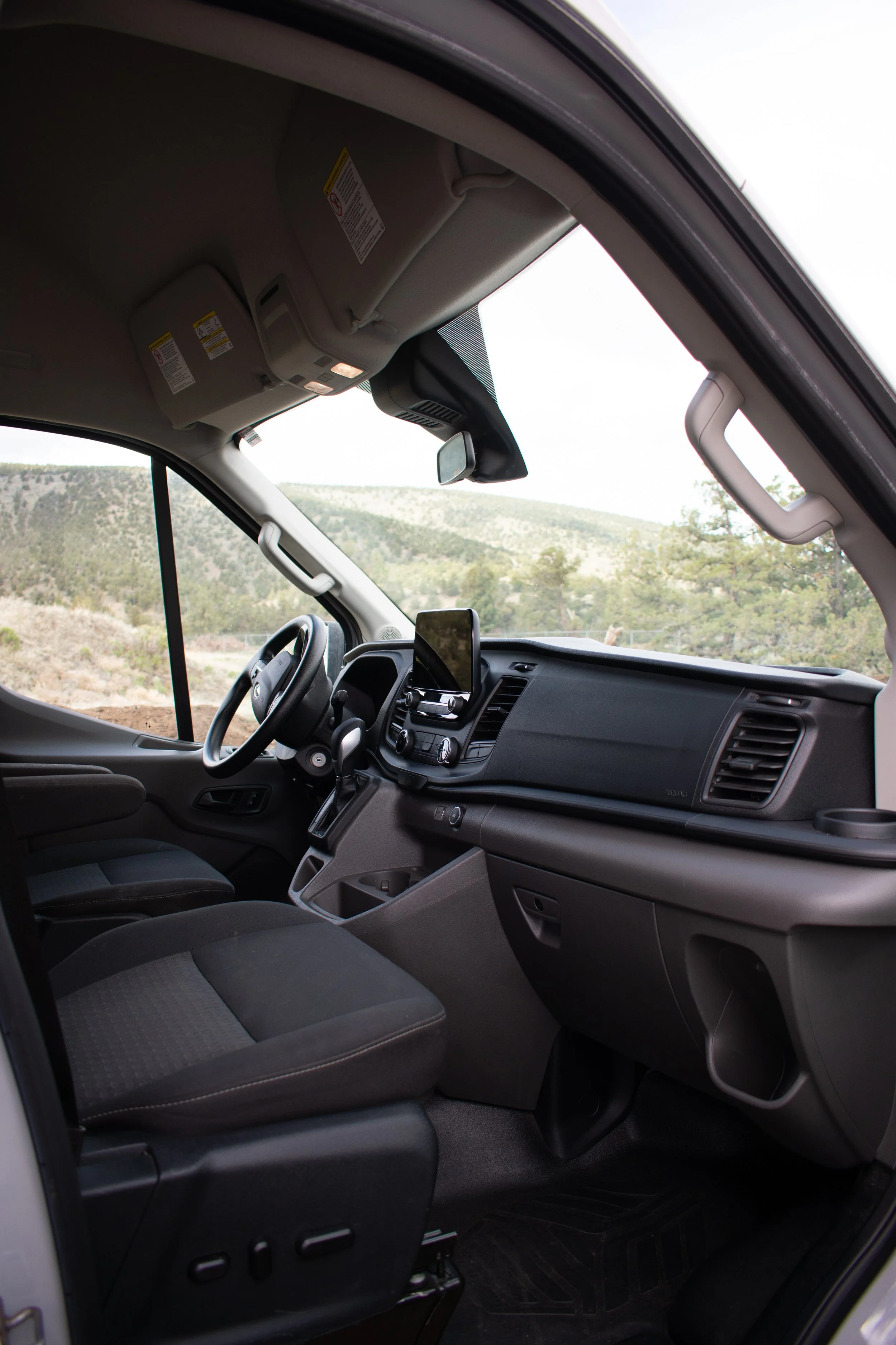 Ford Transit camper van cab with modern driver and passenger seating – Oxbow Vans build
