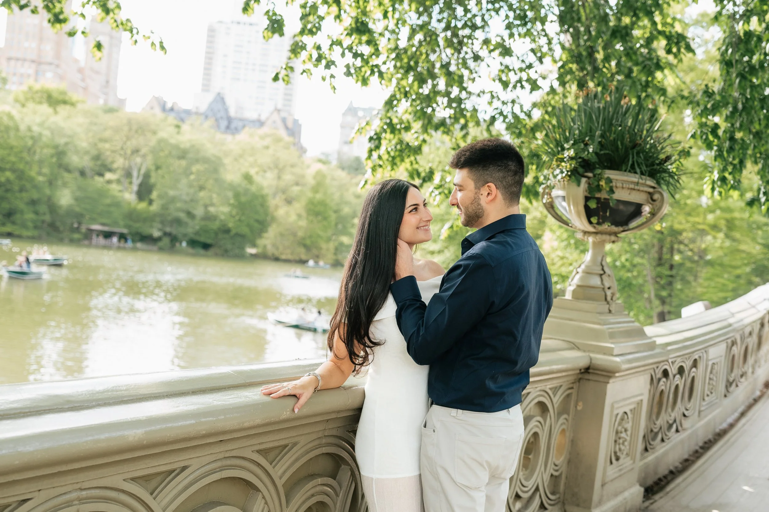 Elegant engagement portrait in Central Park featuring the New York City skyline and timeless documentary photography.