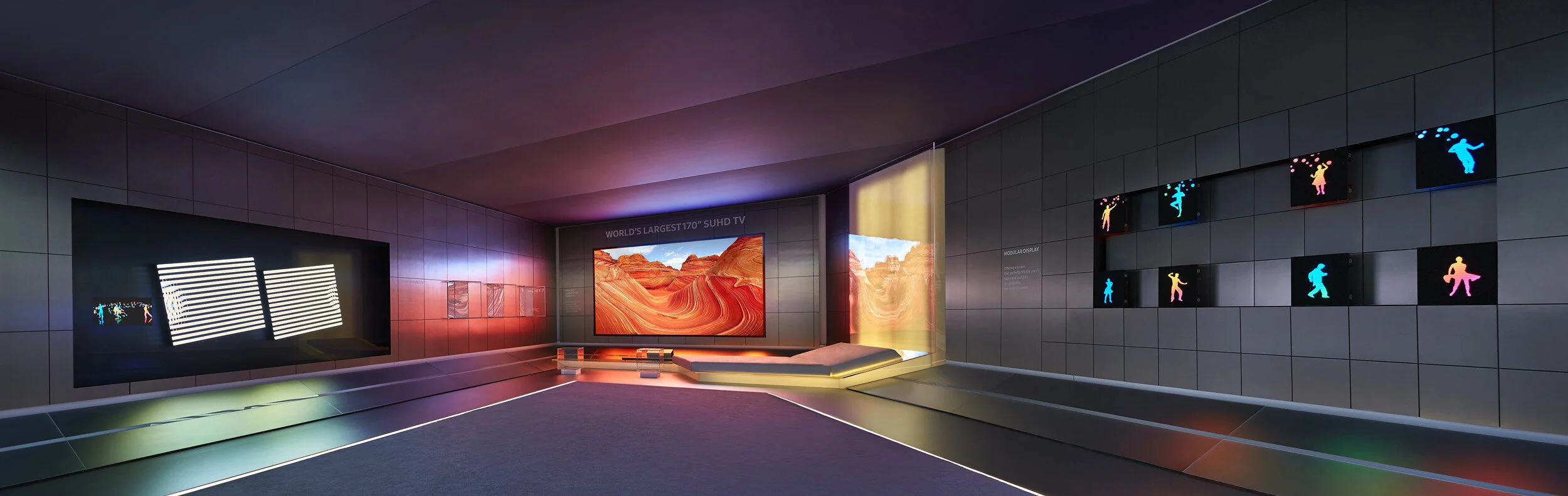 Contemporary room with multiple TV screens inside Samsung exhibit booth at CES conference in Las Vegas.