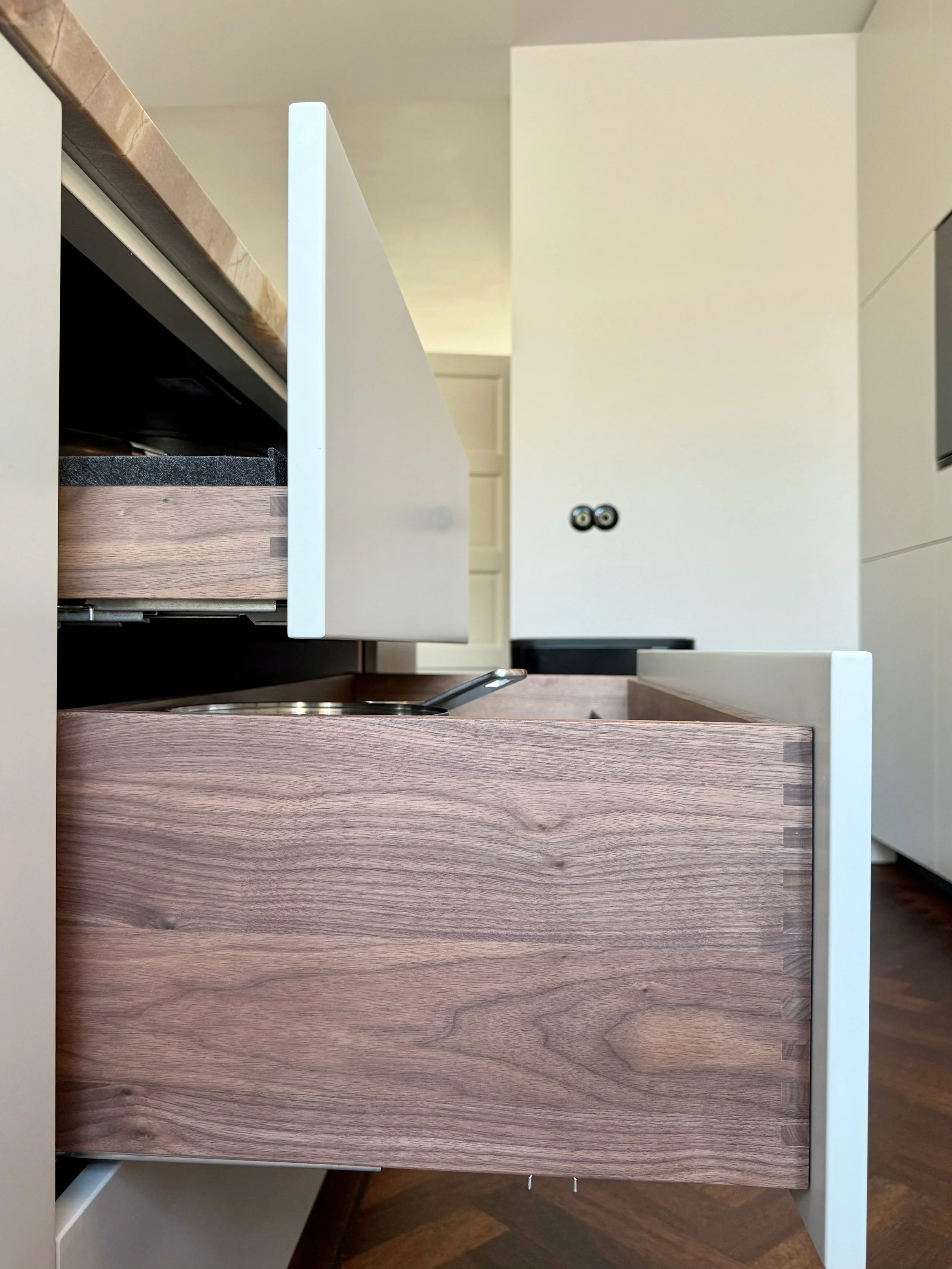 Craftsmanship in every detail with custom walnut drawers. Kitchen designed by Studio GD Interiors.
