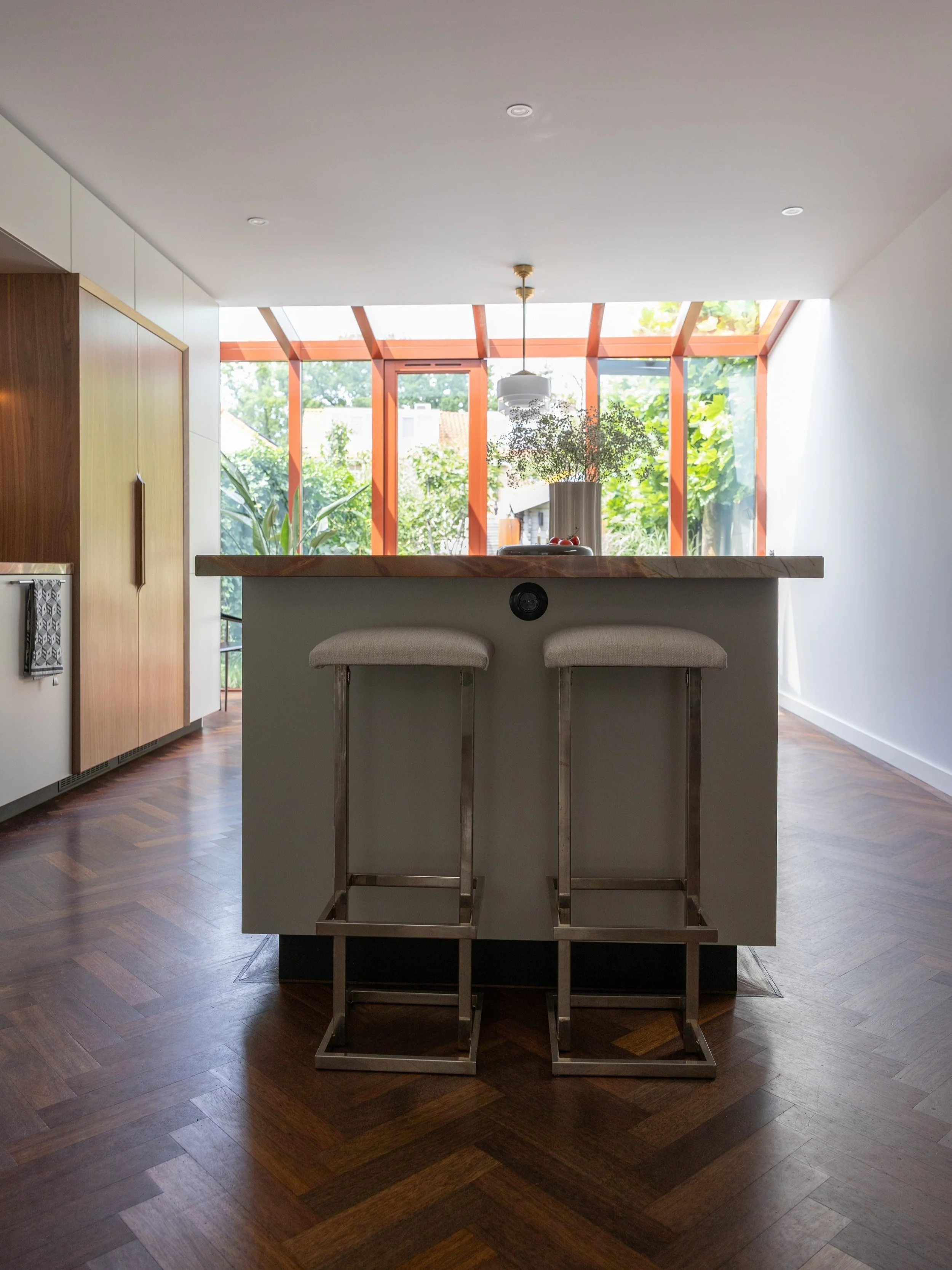 Studio GD kitchen island: Vintage stools, wood flooring, Gispen pendant lights.