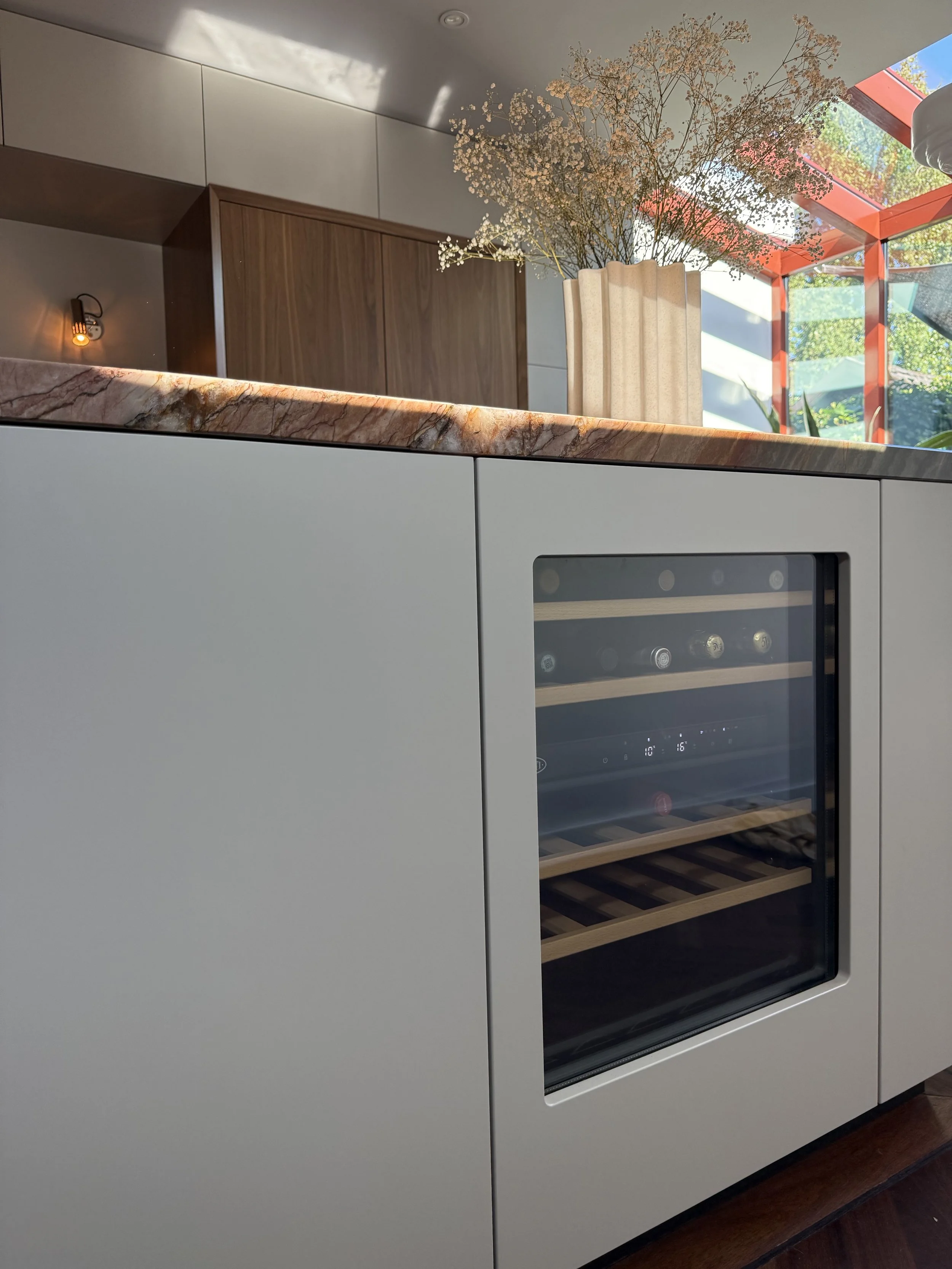 Studio GD Interiors_Close up of the sleek built-in wine climate cabinet, and a striking Quartzite countertop, bleding modern minimalism with natural elements..