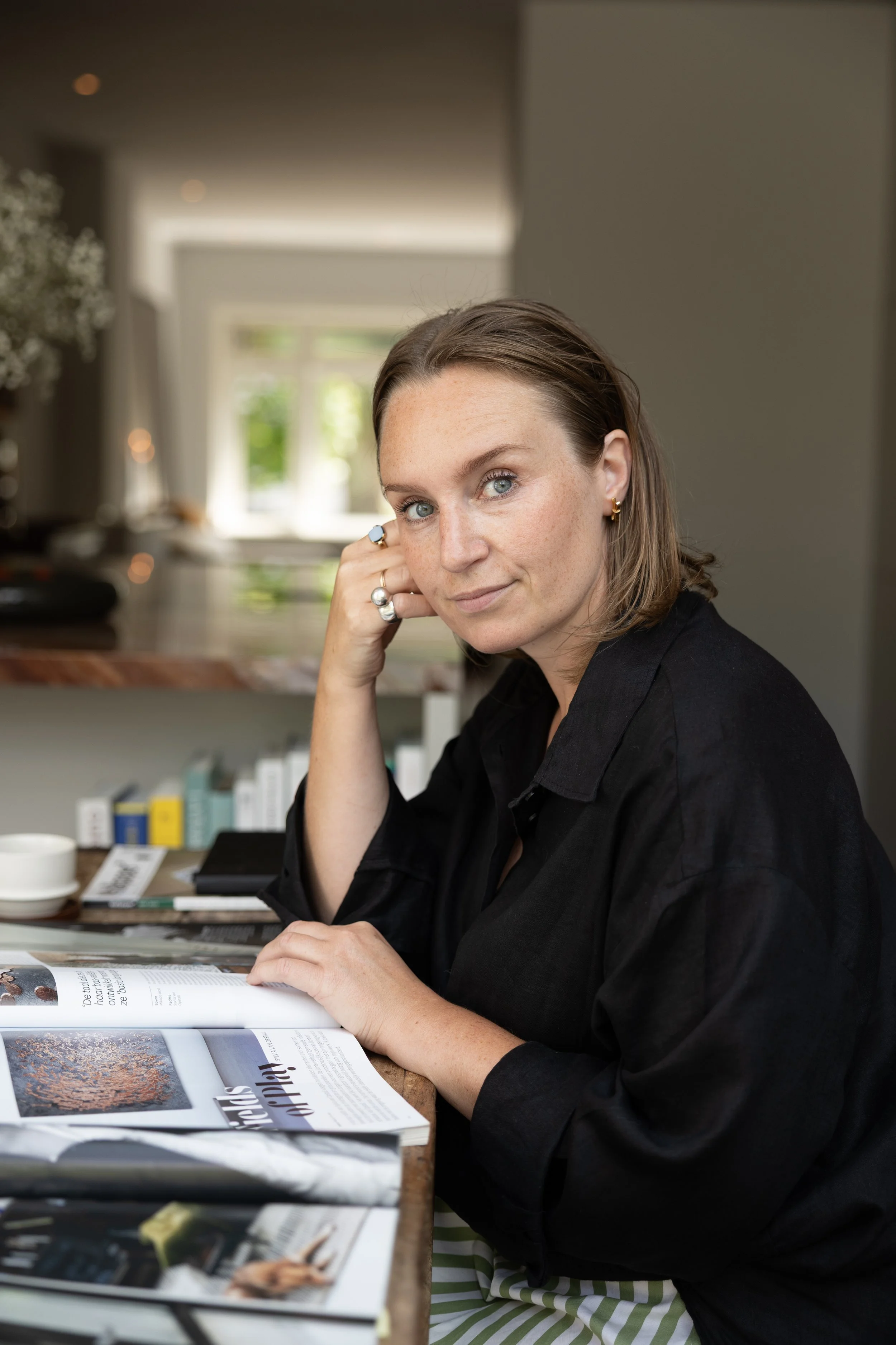 Gisela Draijer, owner of Studio GD. Standing in her latest interior design project, a modern kitchen with natural quartzite countertop. A calm, warm space that feels open yet grounded. Designed for living.