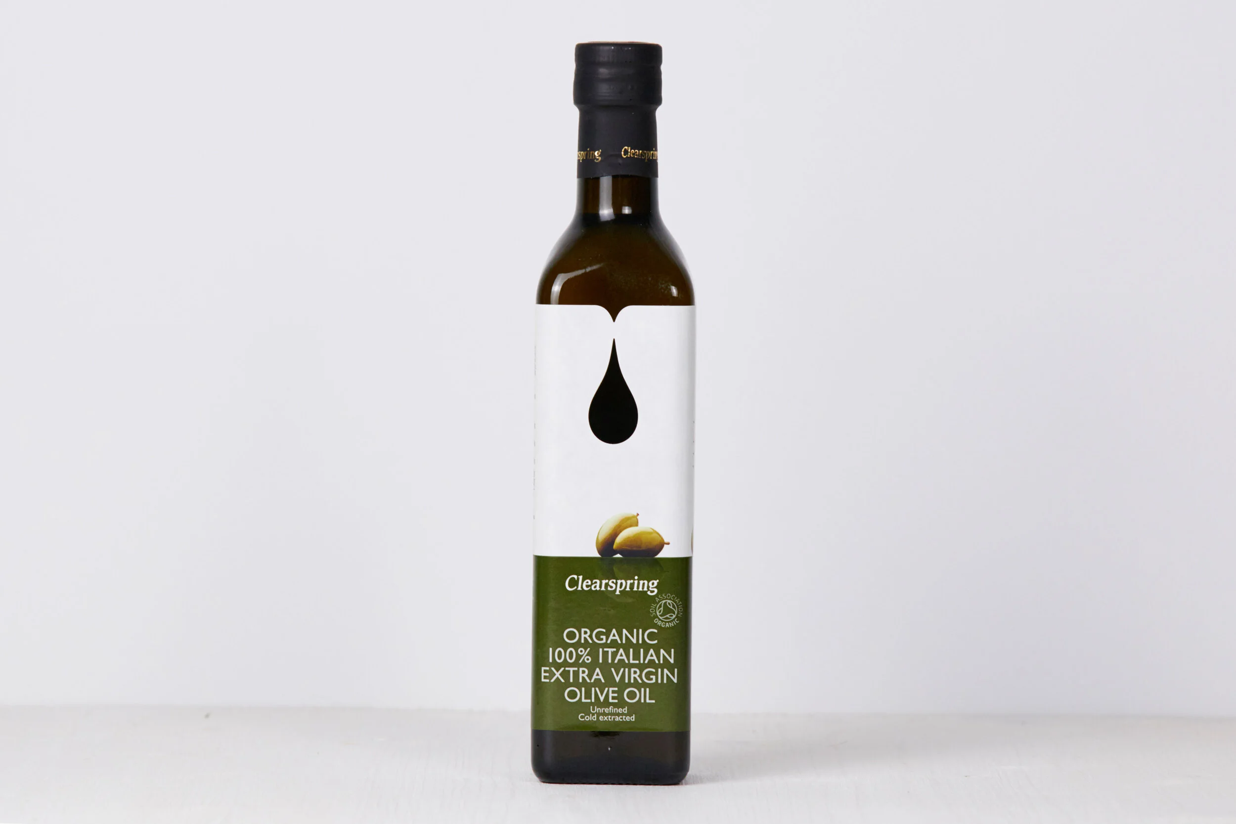 A bottle of Clearspring organic extra virgin Italian olive oil with a minimalist white and green label, featuring a black oil drop logo and image of two olives, against a plain white background.