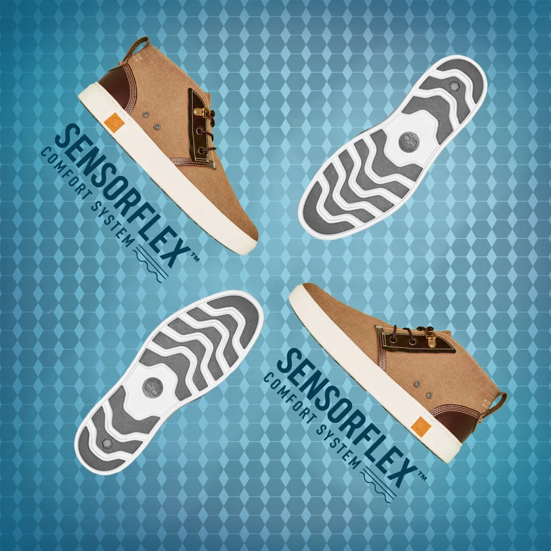 Two pairs of brown sneakers with white soles and black and white patterned outsoles on a blue textured background, with the 'SENSORELEX COMFORT SYSTEM' logo.
