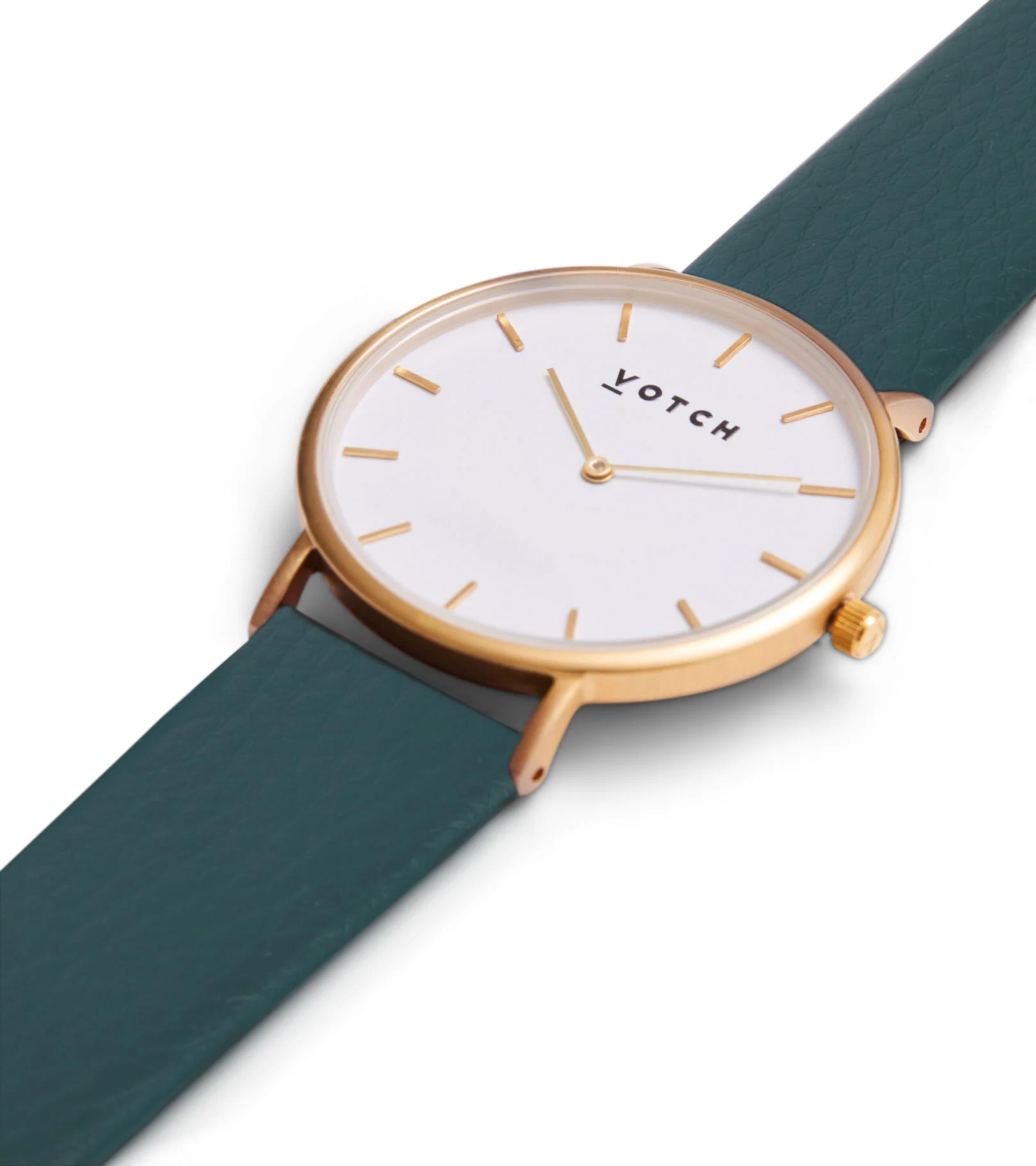 A wristwatch with a gold case, white dial, gold hour markers, and hands, along with a dark green strap. The watch face displays the brand name 'Votch'.