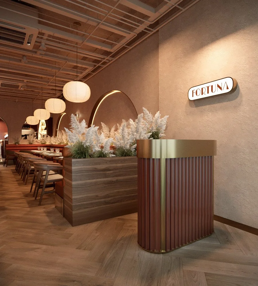Modern restaurant interior with a wooden reception desk, white pampas grass plants, hanging paper lantern lights, and a sign that reads 'FORTUNA' on the wall.