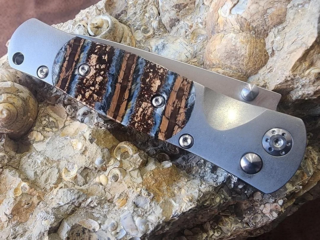 One knife with mammoth tooth handle on rock