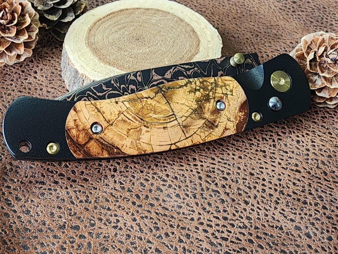 copper and brass Damascus knife with Mammoth ivory inlay on wood with pincones