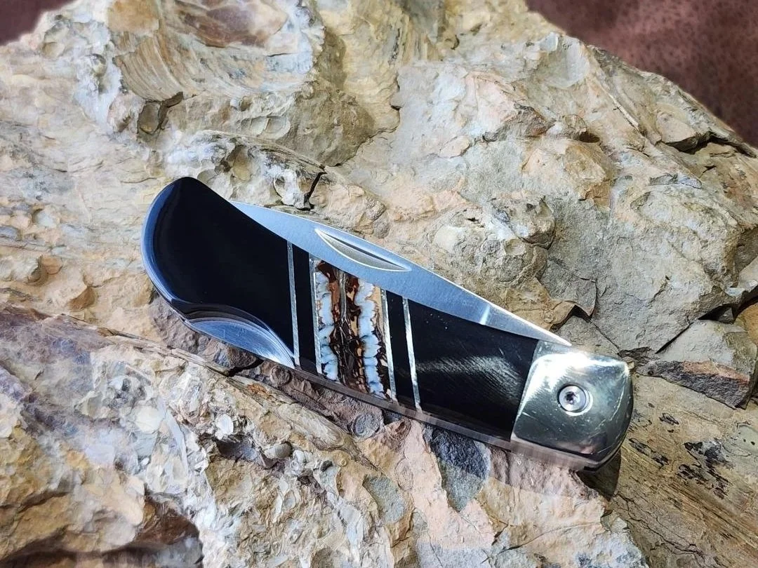 3" knife with mammoth tooth inlay and onyx on rock