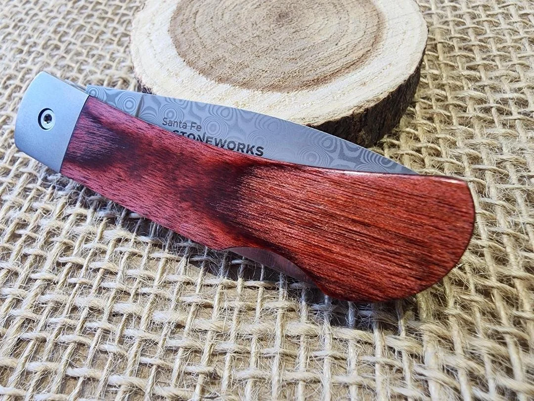 3" knife with red stabilized birch wood with a burlap and wooden background