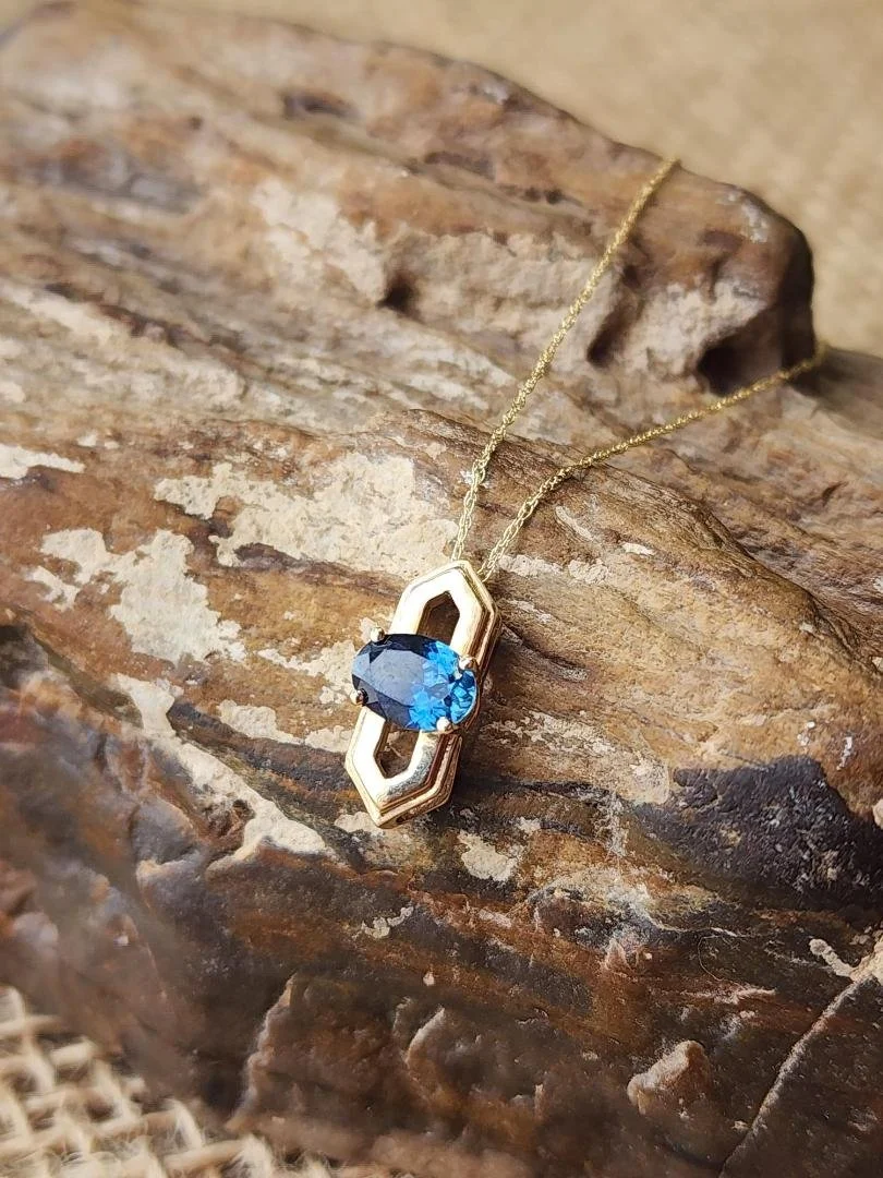 yellow gold Montana sapphire on agatized wood