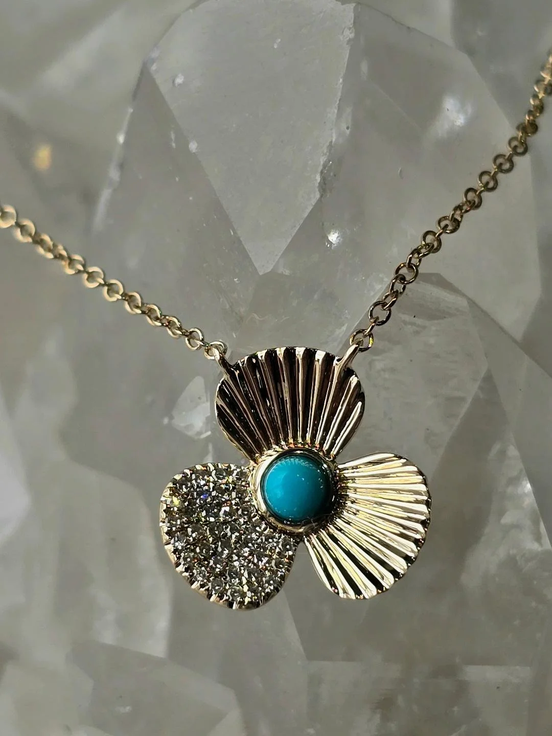 Front view of a flower turquoise pendant of a crystal background