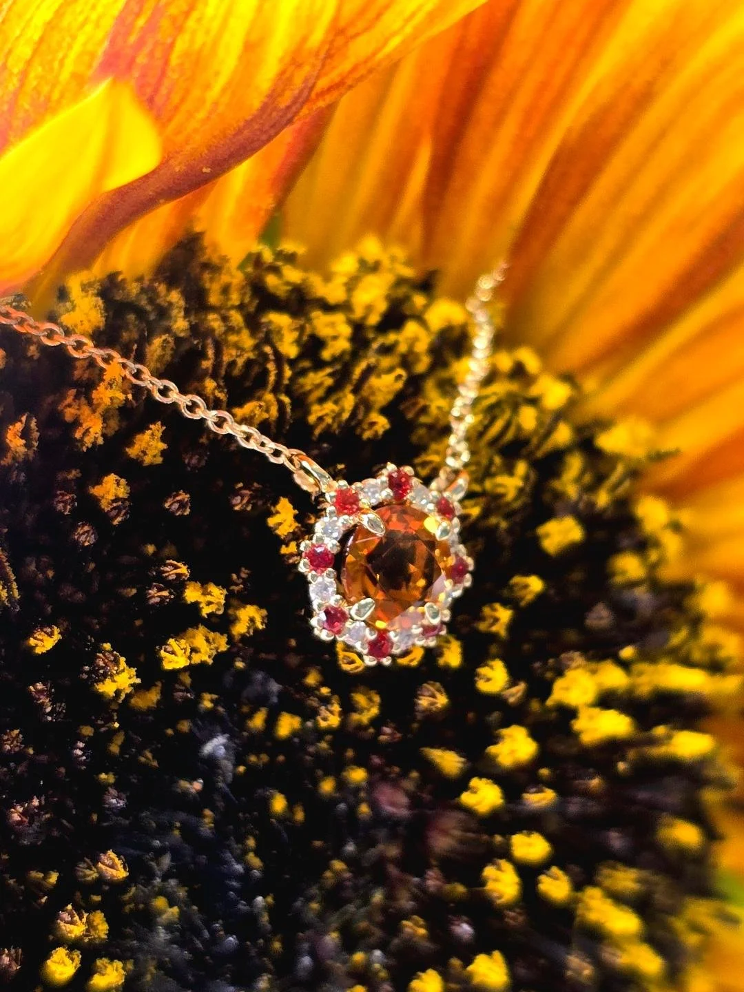 Side view of a stationary citrine necklace on sunflower background