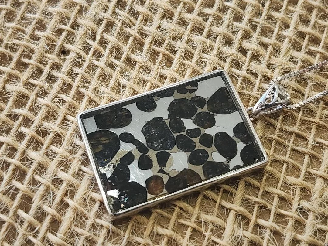 rectangular necklace with Sericho meteorite on a burlap background