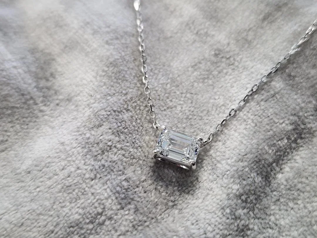 solitaire lab grown diamond necklace in sterling silver on grey fabric