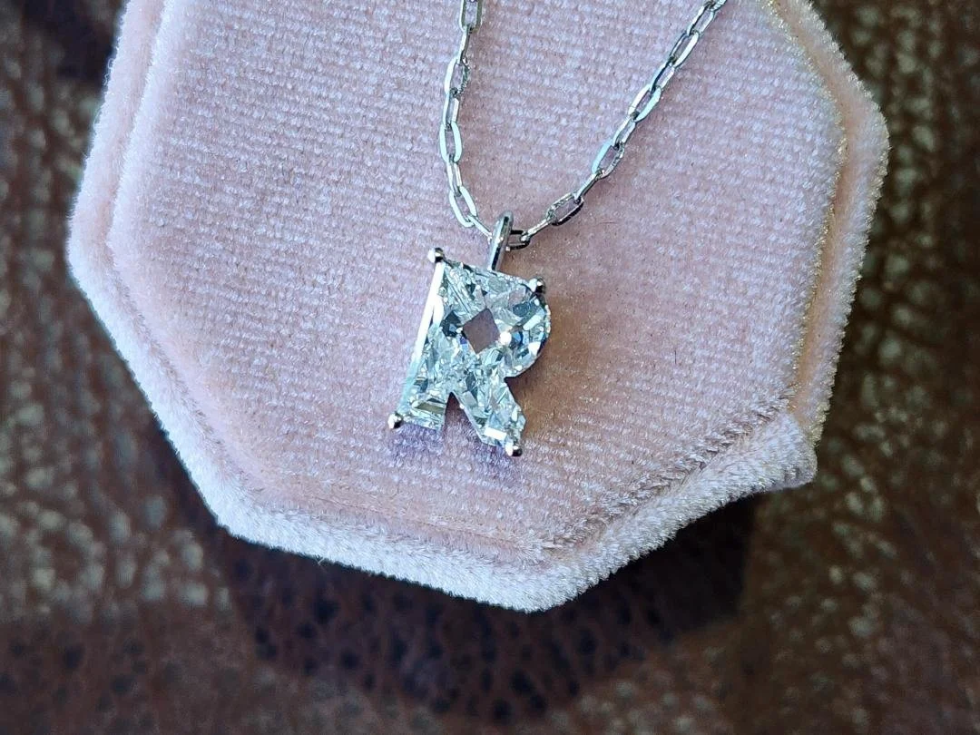 Fancy Cut R lab grown diamond necklace in white gold on a pink box