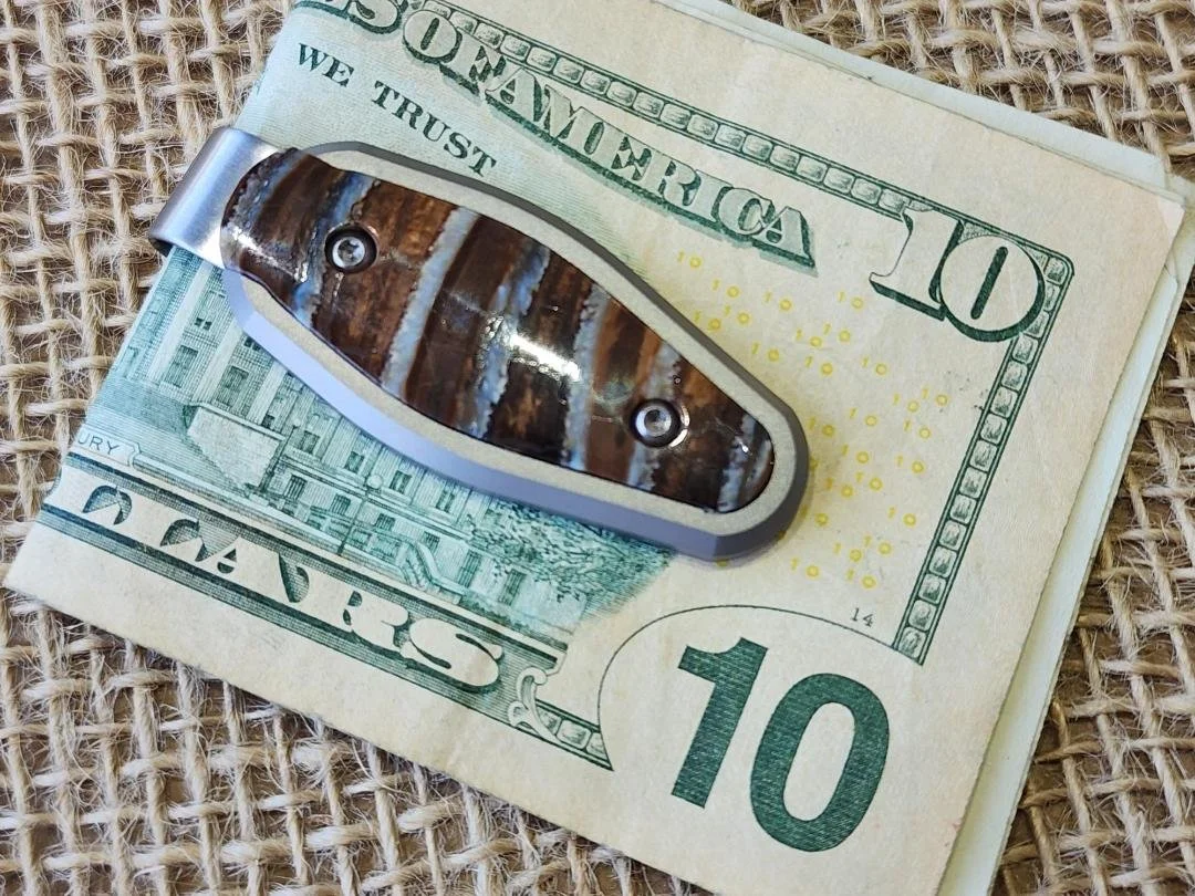 money clip inlayed with mammoth tooth on burlap with money in clip