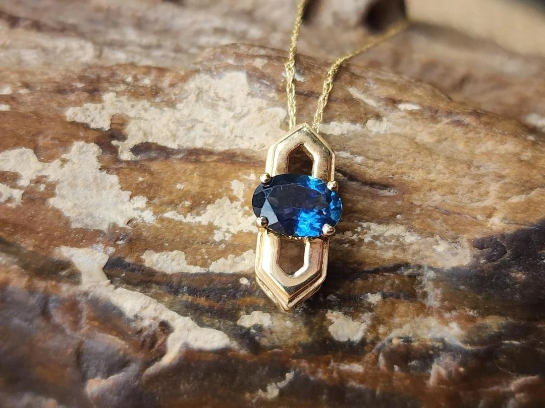 yellow gold Montana sapphire on agatized wood