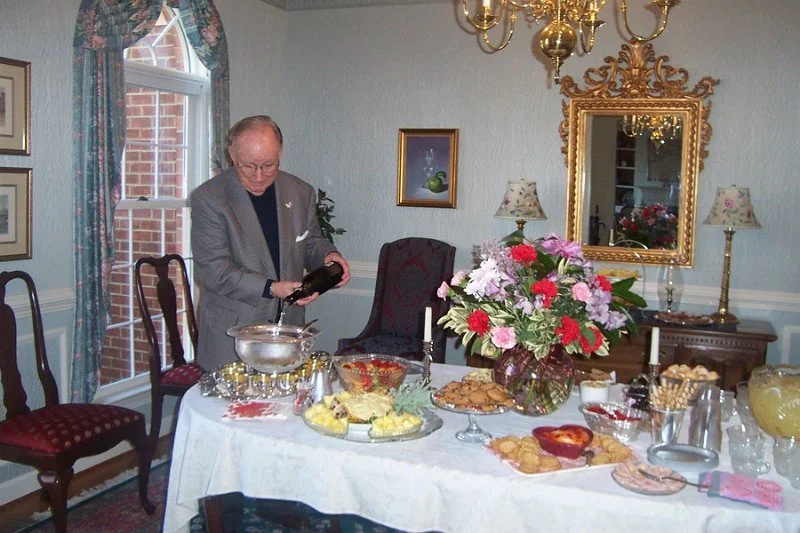 Paul Tongue pours punch for guests