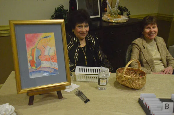 Mim Hettler and Judy Doyle sell raffle tickets