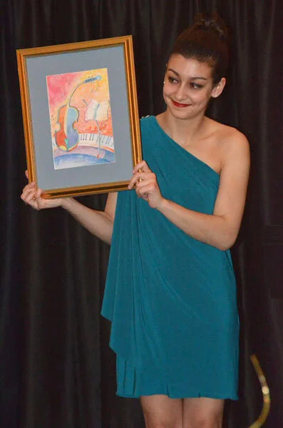 Sophie Leruth holds raffle prize, an original watercolor by Sue Danehy