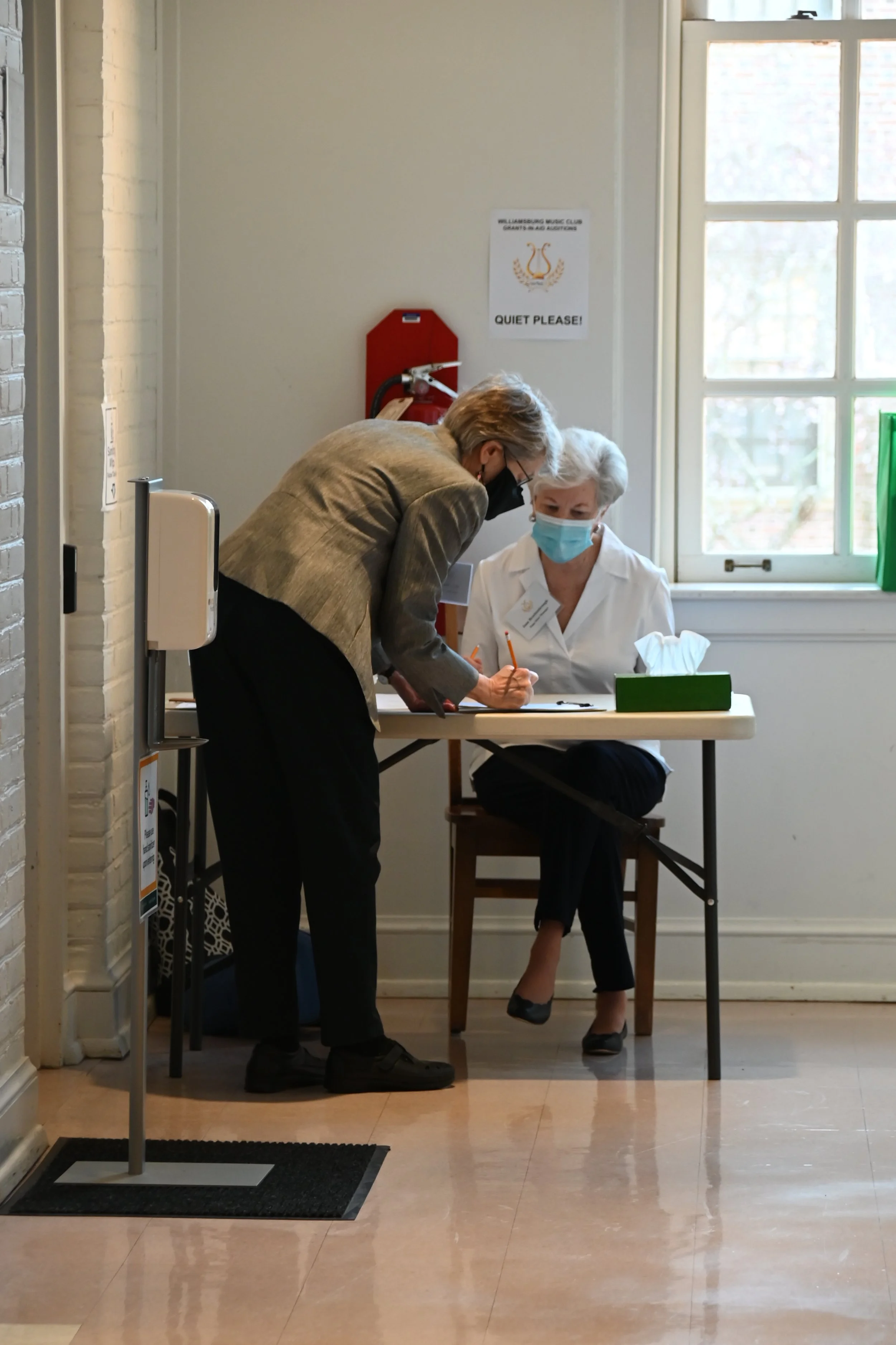 Mary Molineux, Stage Door Assistant, checks with Joan Brockenbough, Stage Door Manager 