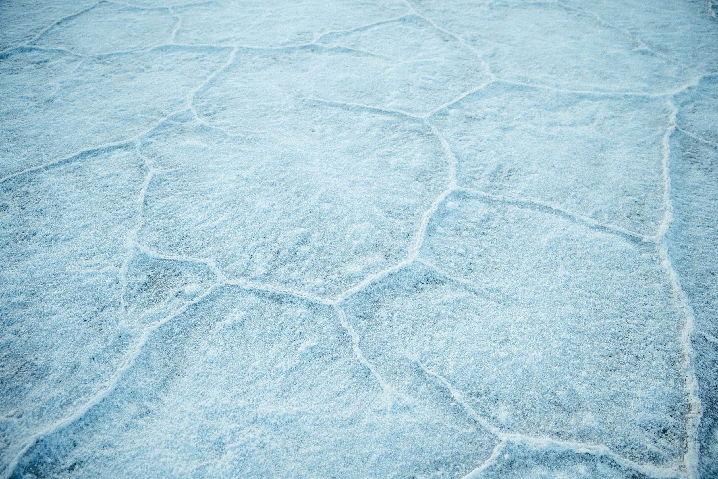 Close-up of ice with visible cracks and a textured surface.