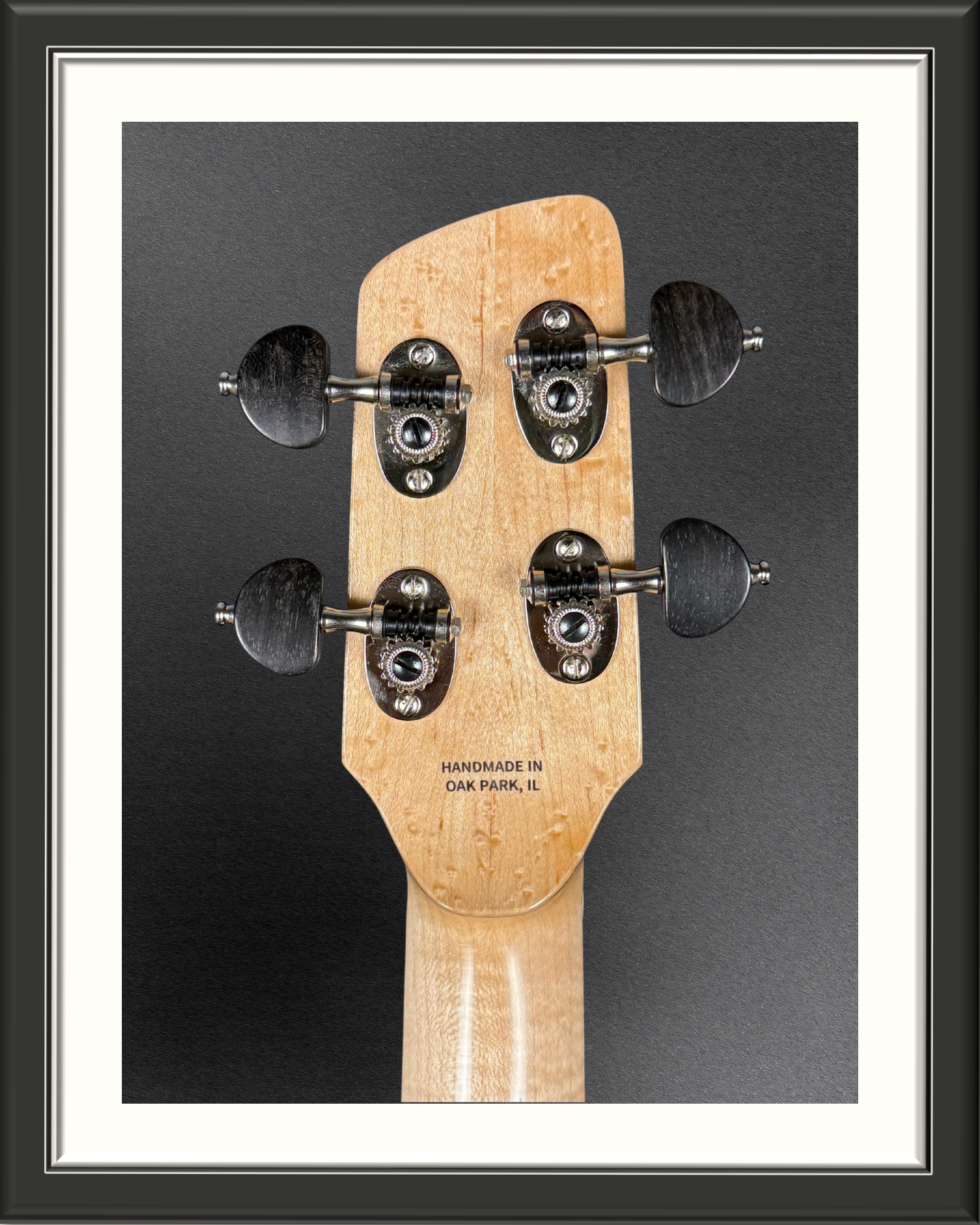 Close-up of the back of the headstock and tuning machines of the MachMachines Cuyler Model all-maple, hollow-body, electric baritone ukulele