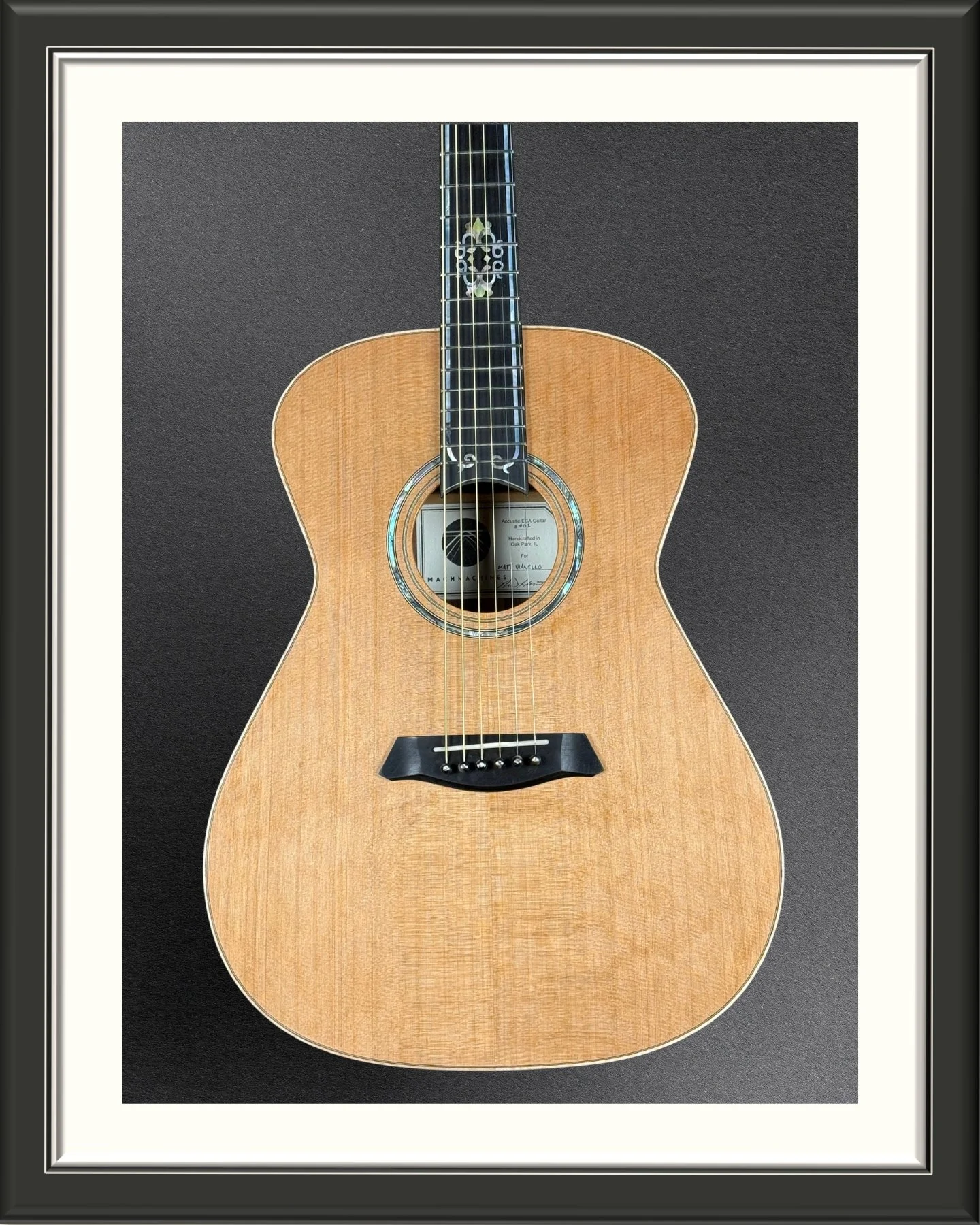 The body of the ECA custom acoustic guitar with Western Red Cedar top and inlayed rosette and fretboard