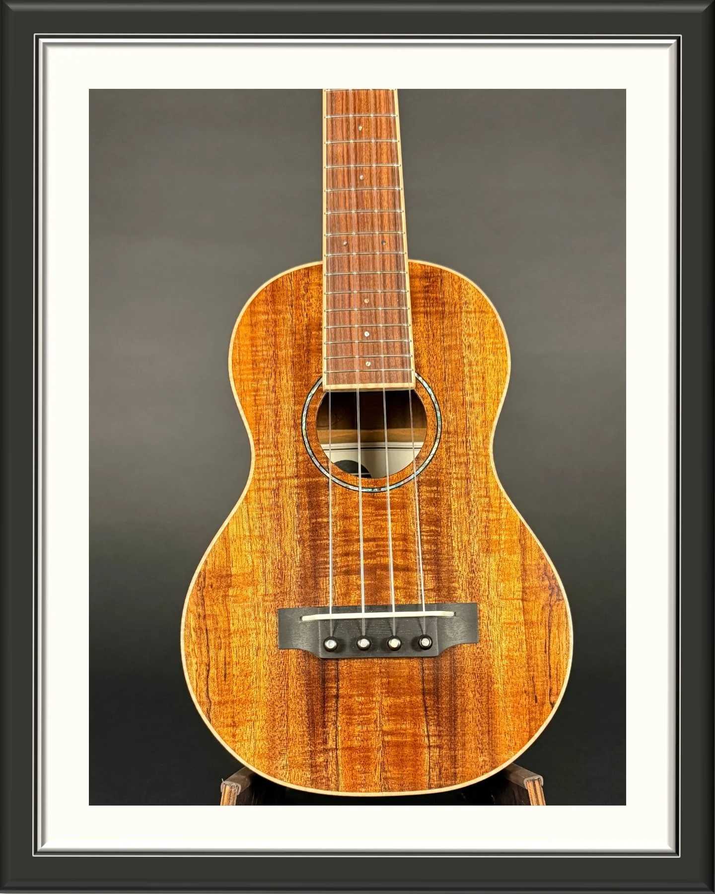 Front of the body of a concert ukulele in Hawaiian Koa