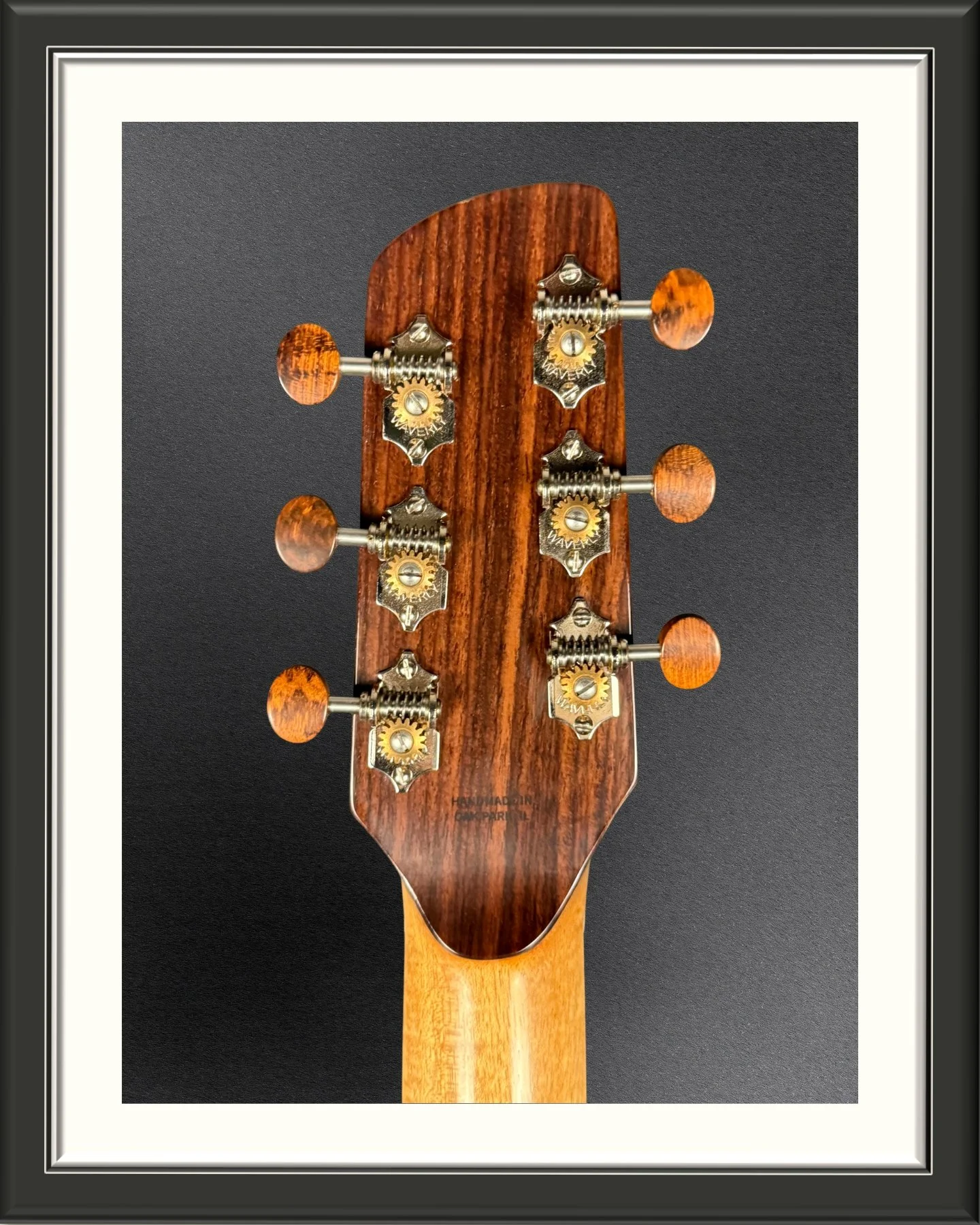 Close up of the back of the headstock of the ECA custom acoustic guitar in Indian Rosewood