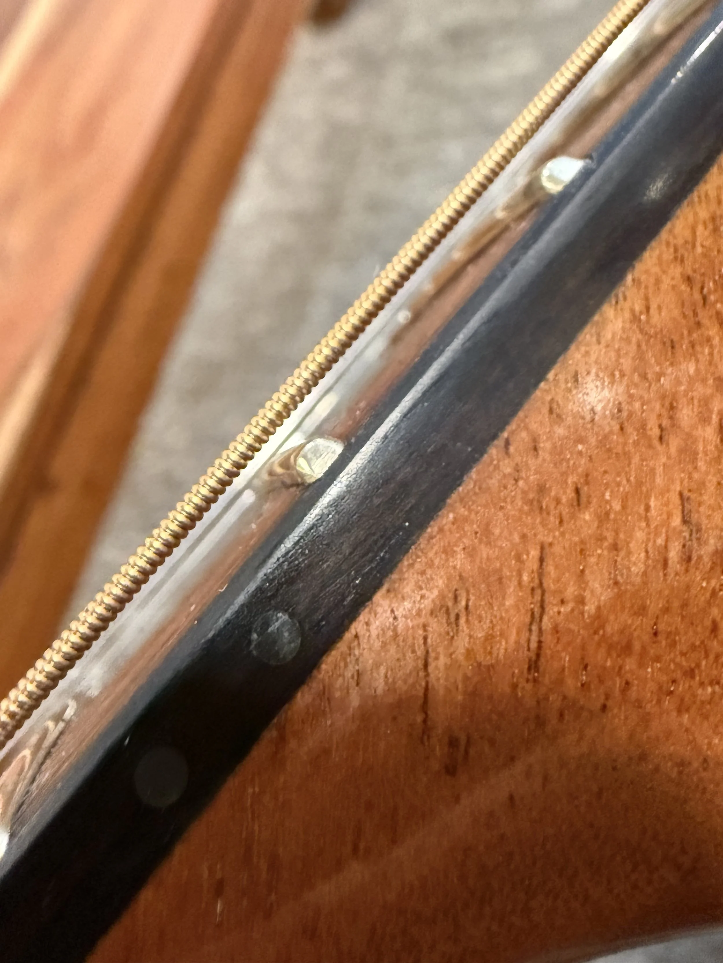 The distance between a guitar fret and string