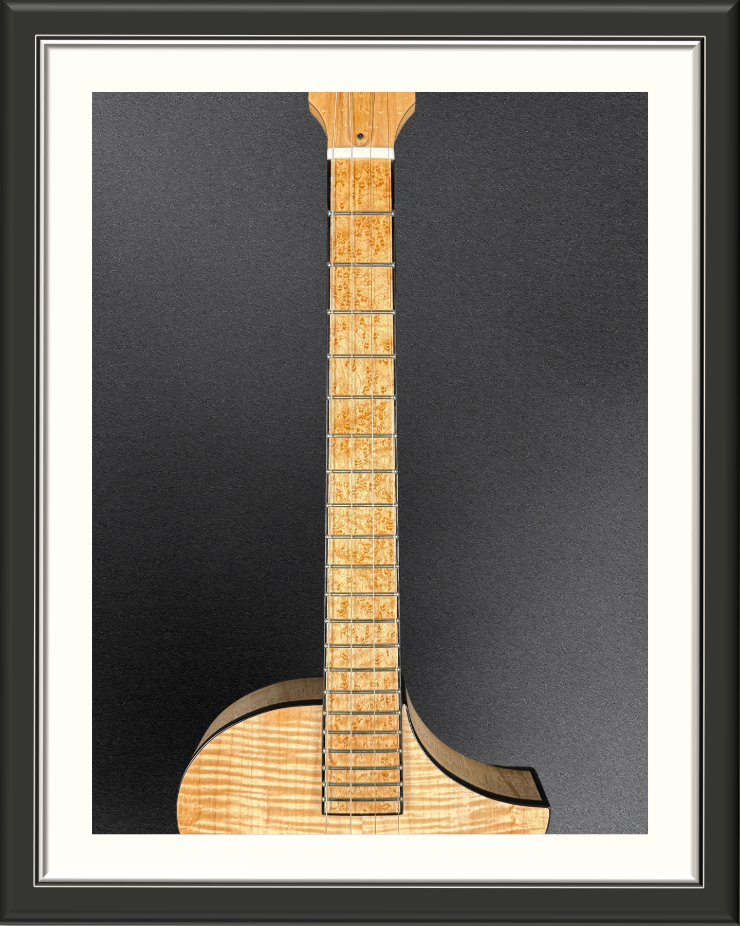 Birdseye maple fretboard of the MachMachines Cuyler Model all-maple, hollow-body, electric baritone ukulele