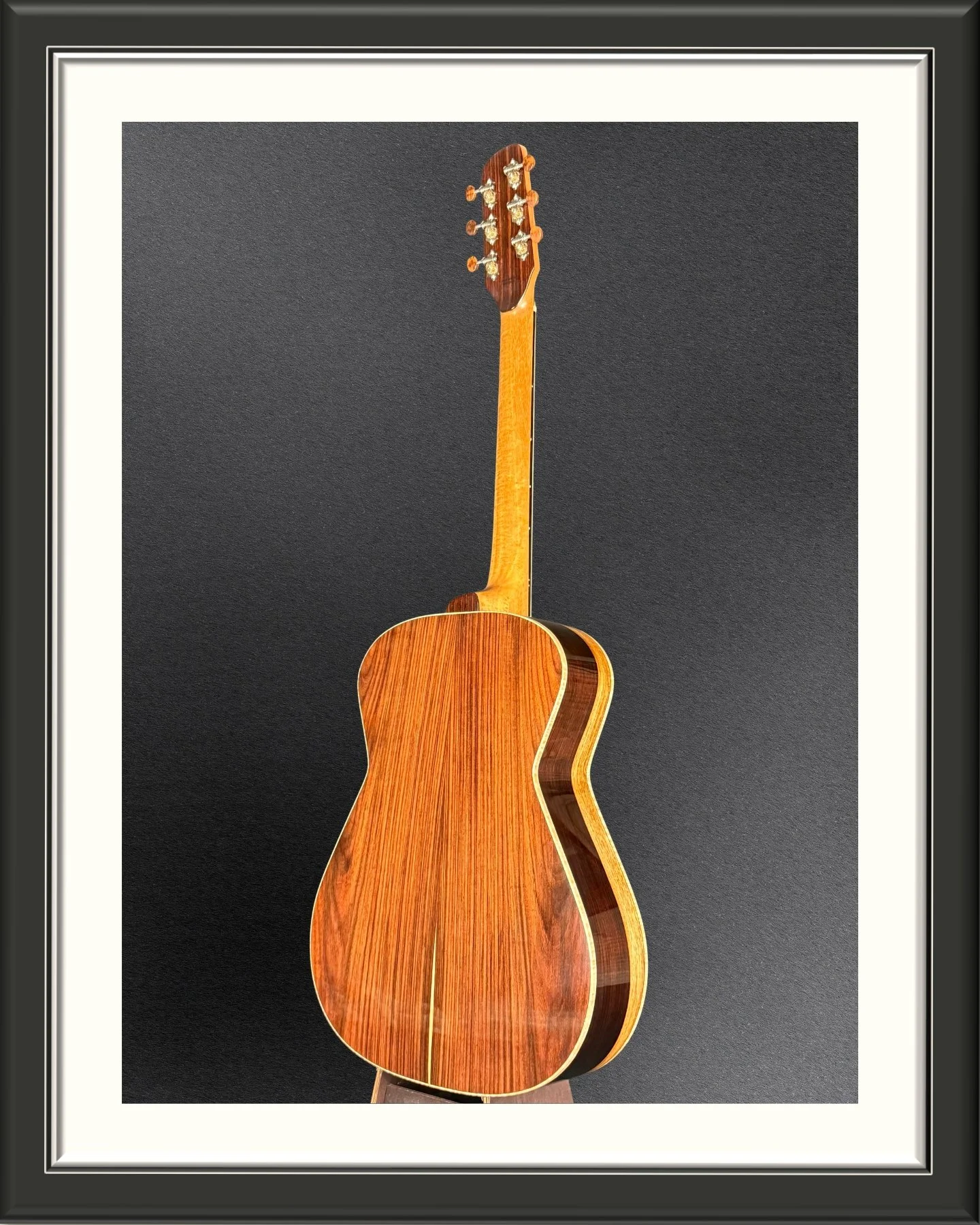 Full image of the back of the ECA custom acoustic guitar with Nicaraguan Rosewood back and sides, facing to the left