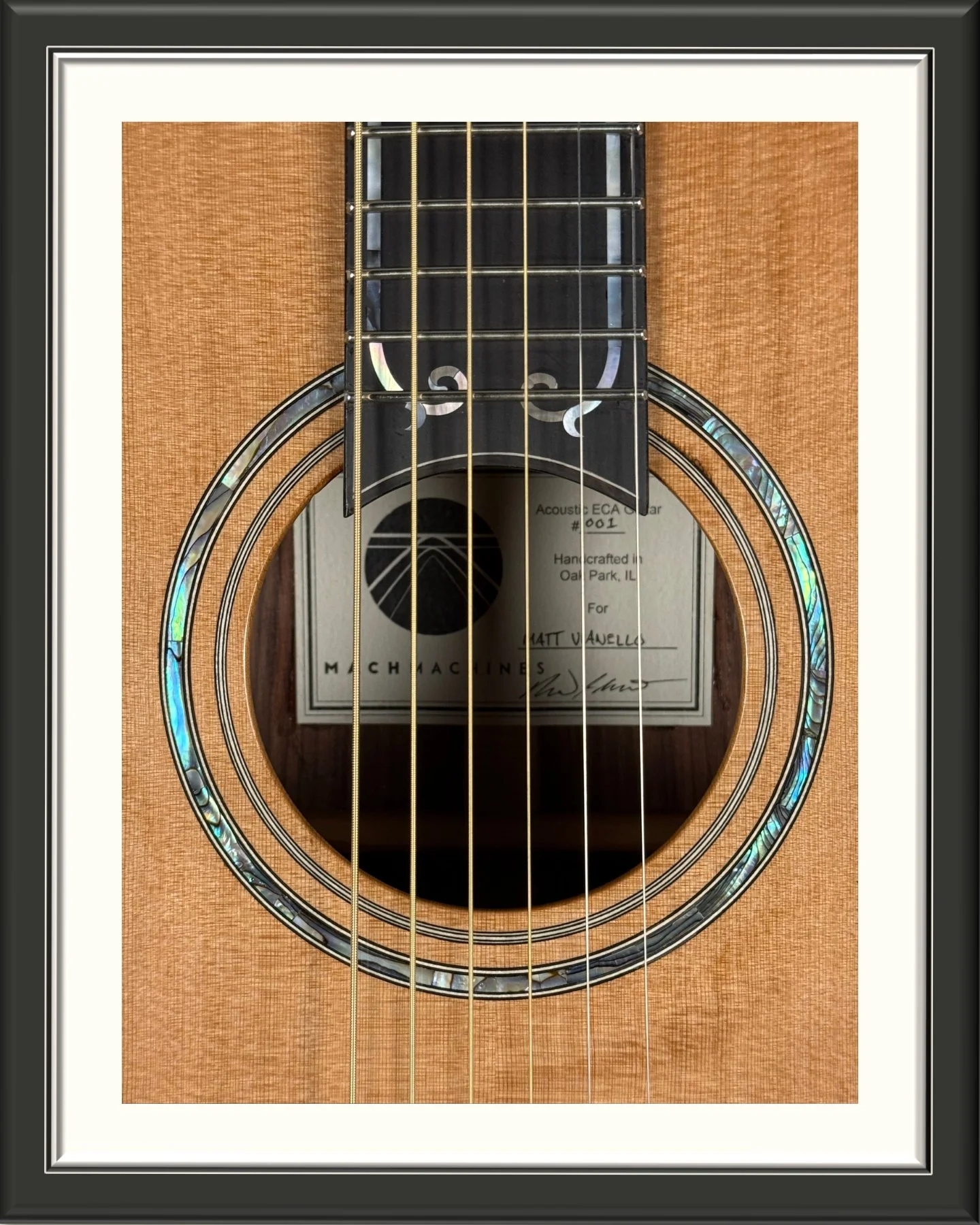 Close up of the abalone shell rosette of the ECA custom acoustic guitar