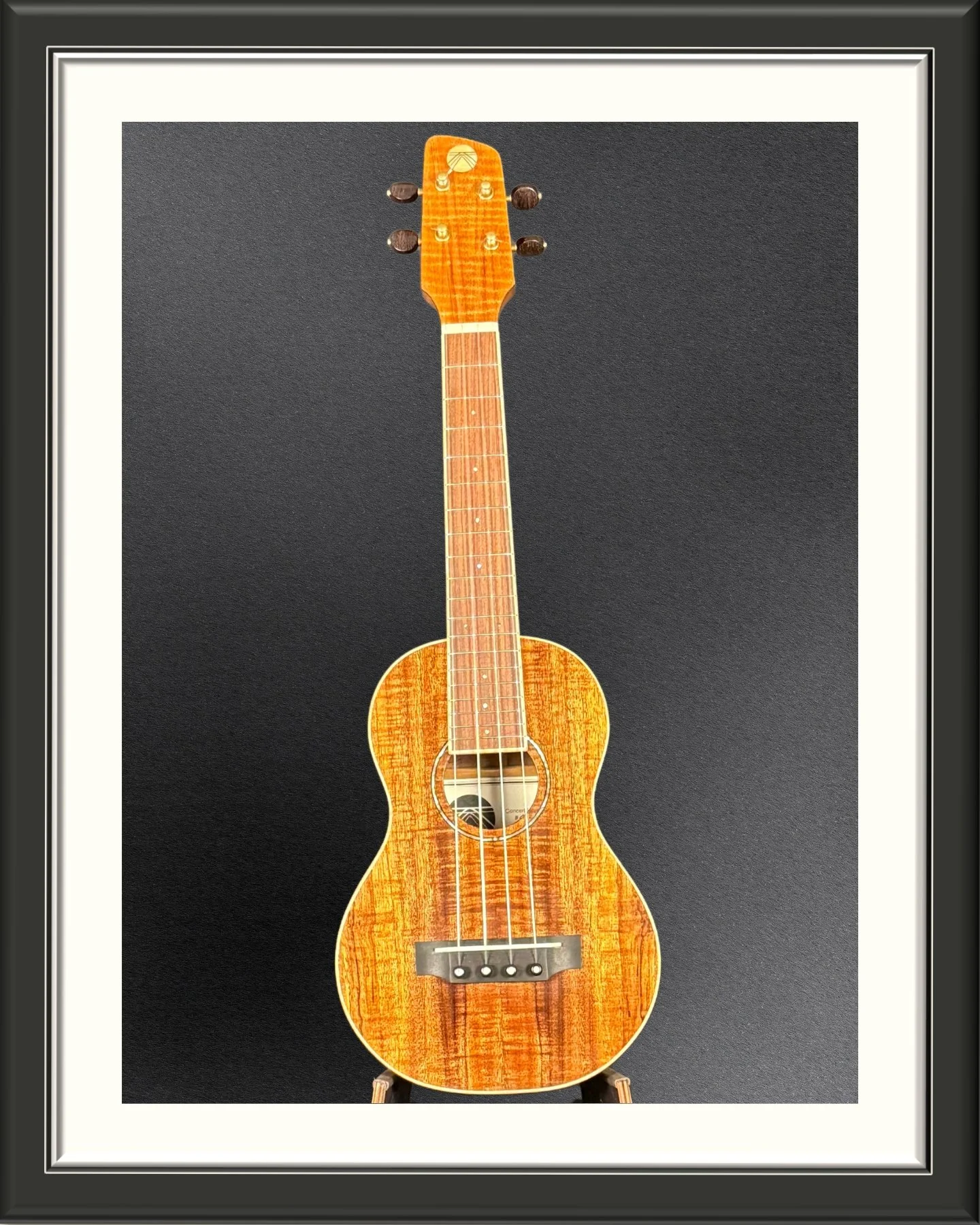 Front of a MachMachines concert ukulele in Hawaiian Koa