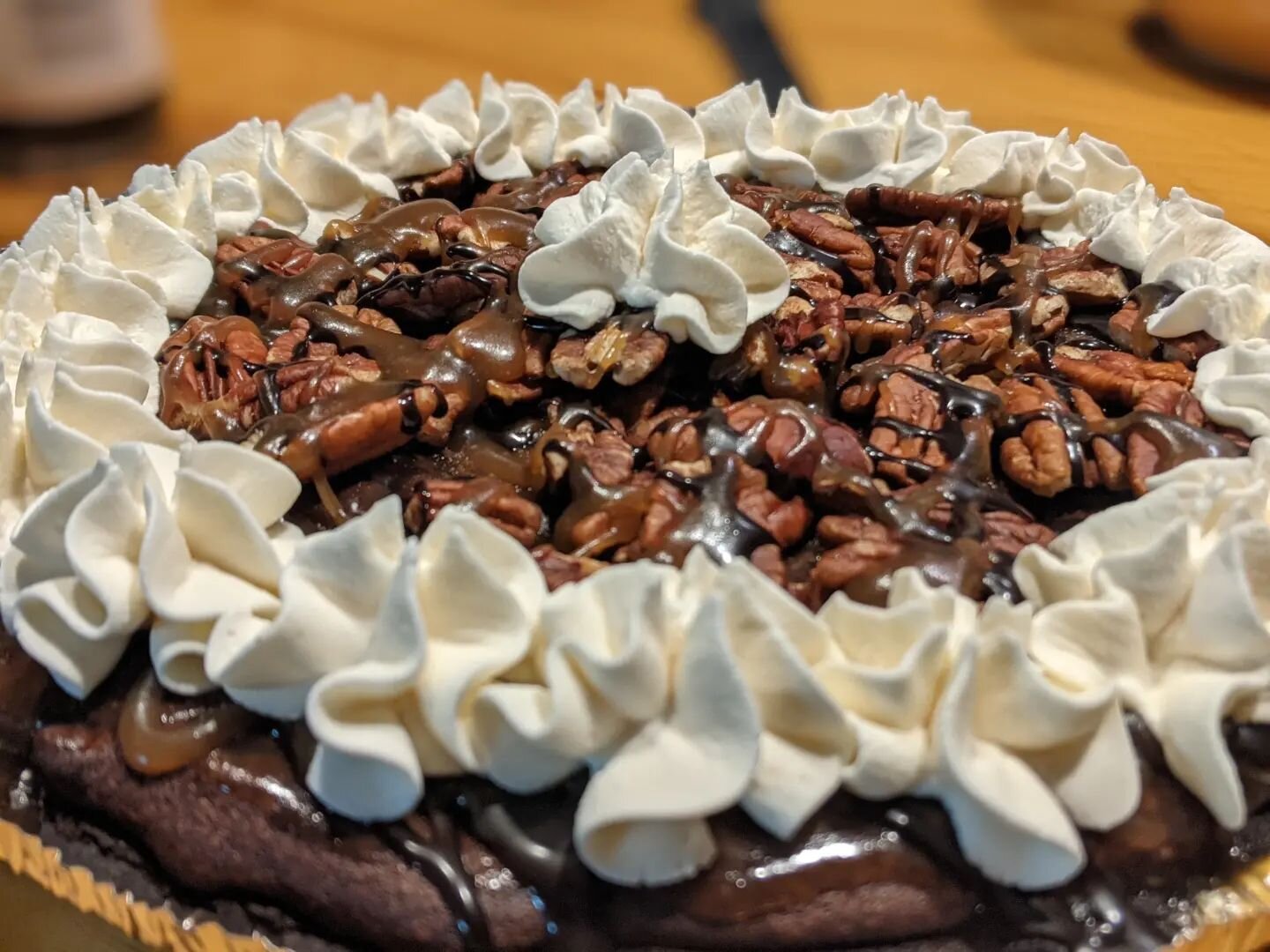 So! I was feeling a little ambitious last night and decided to make something new.

This is an Oreo pie crust filled with pecan and chocolate chip brownies and then baked. I then topped it with toasted pecan halves, made a homemade caramel drizzle, m