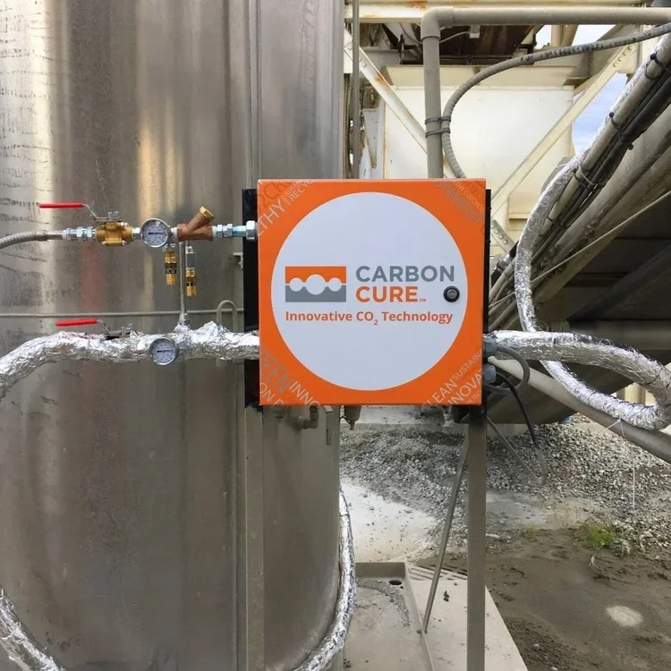 CarbonCure Technologies injects captured CO₂ into concrete during production, permanently mineralising the gas while incorporating recycled industrial by-products into the mix. The result is a stronger, lower-carbon building material that transforms 