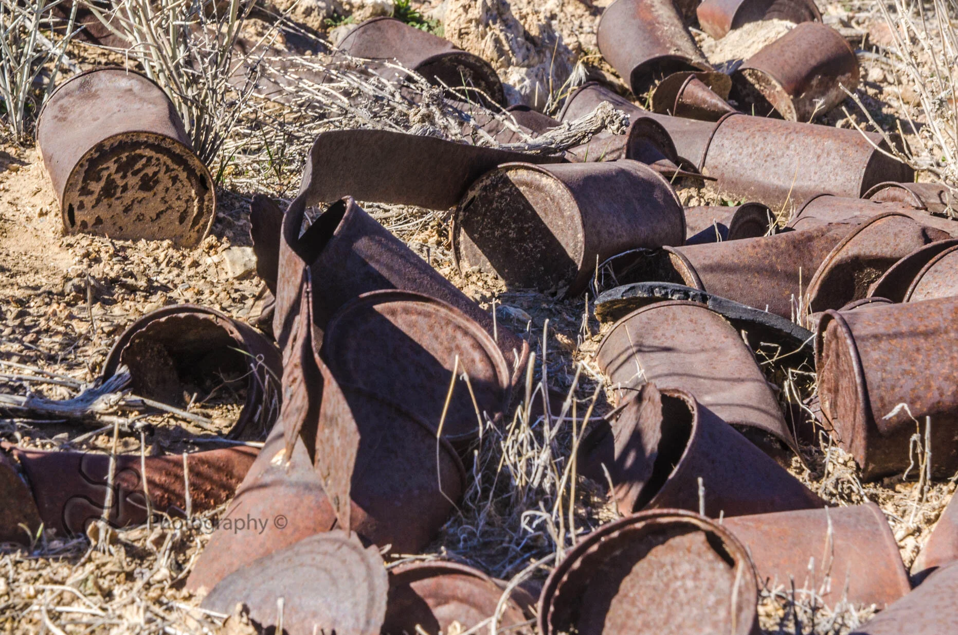 Tin can sit sun faded next to an old mine camp in Shoshone, CA. It will take years before the sand covers these from view. ©2018 Shannon Beelman