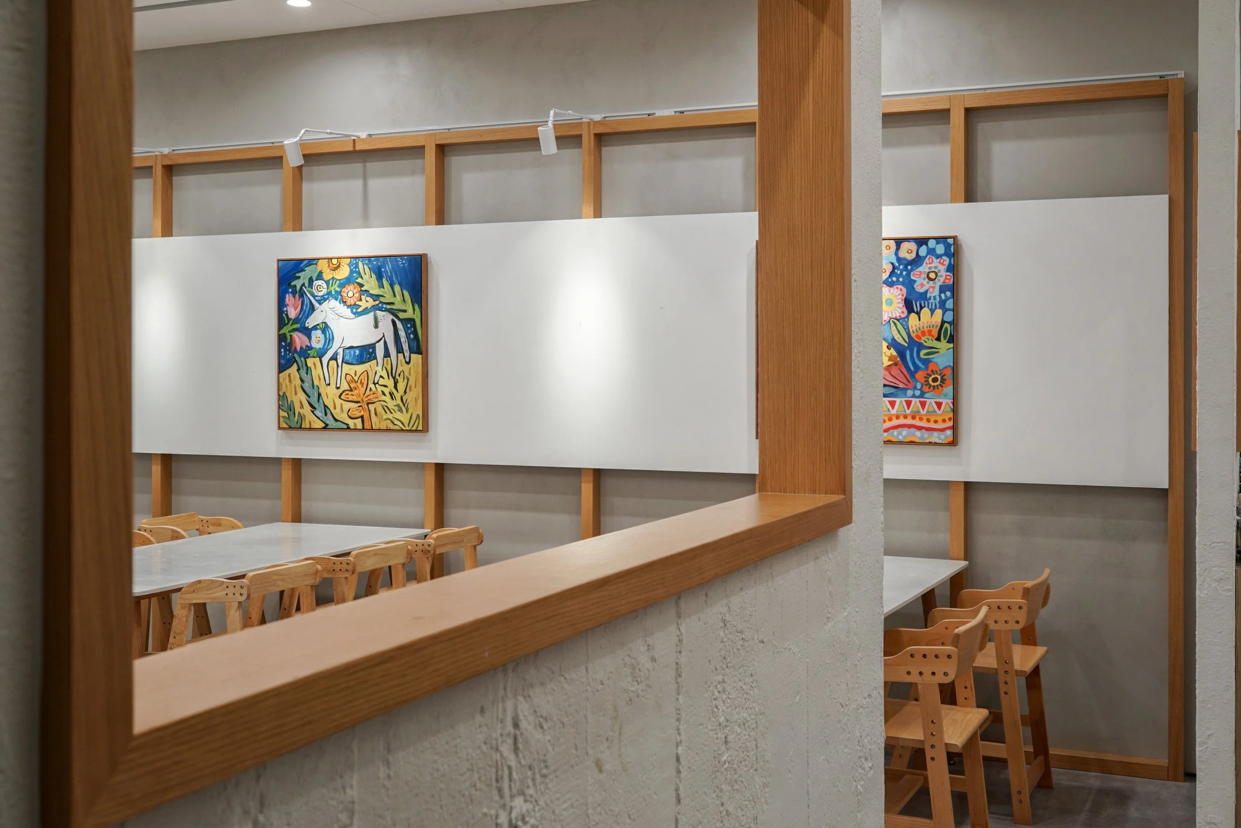 Rectangular timber frames defining the reception and teaching areas at The White Box