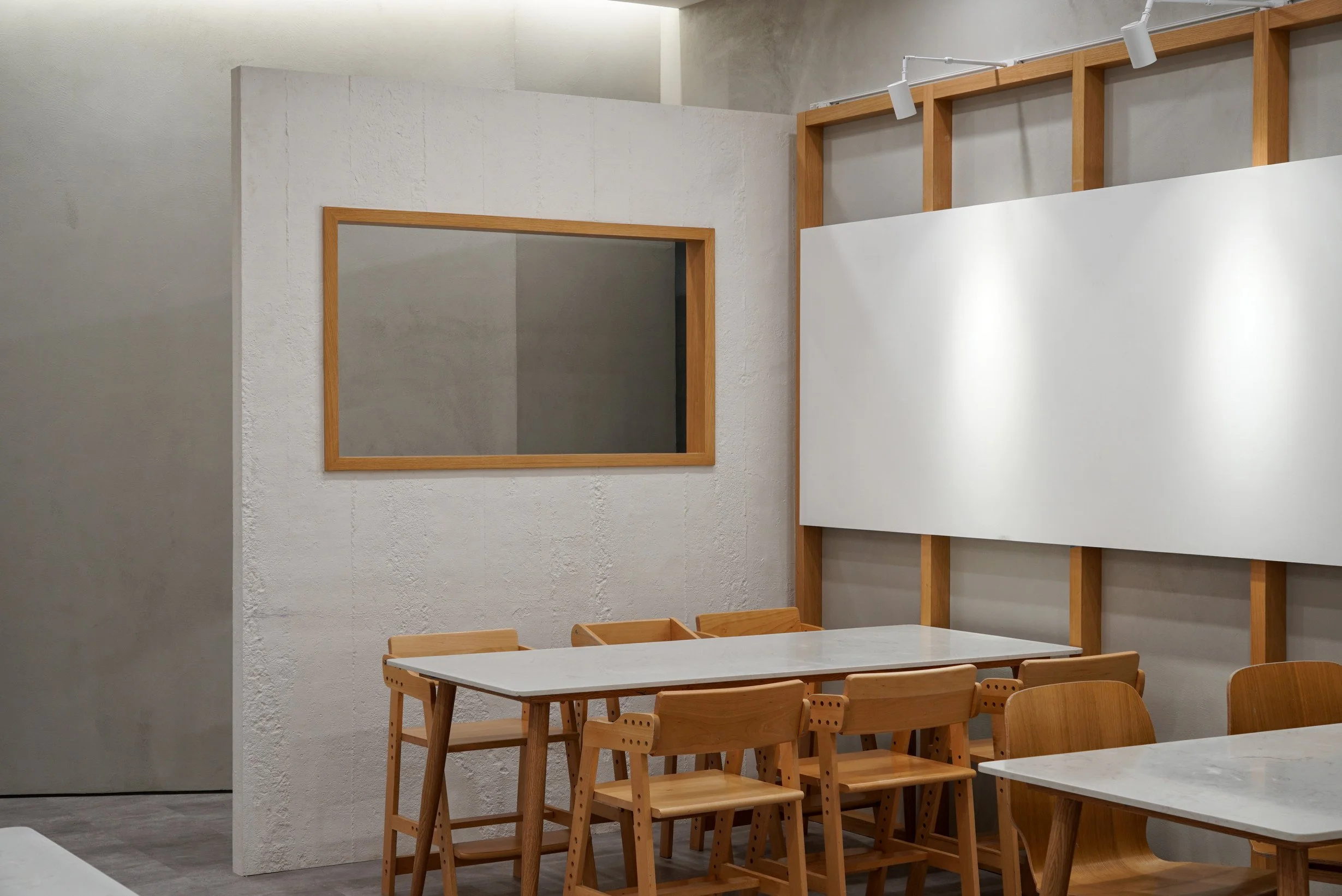 Rectangular timber frames defining the reception and teaching areas at The White Box