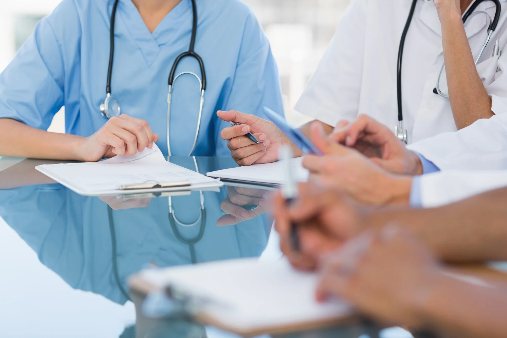 Three medical professionals collaborating on integrative patient care at East-West Integrated Wellness
