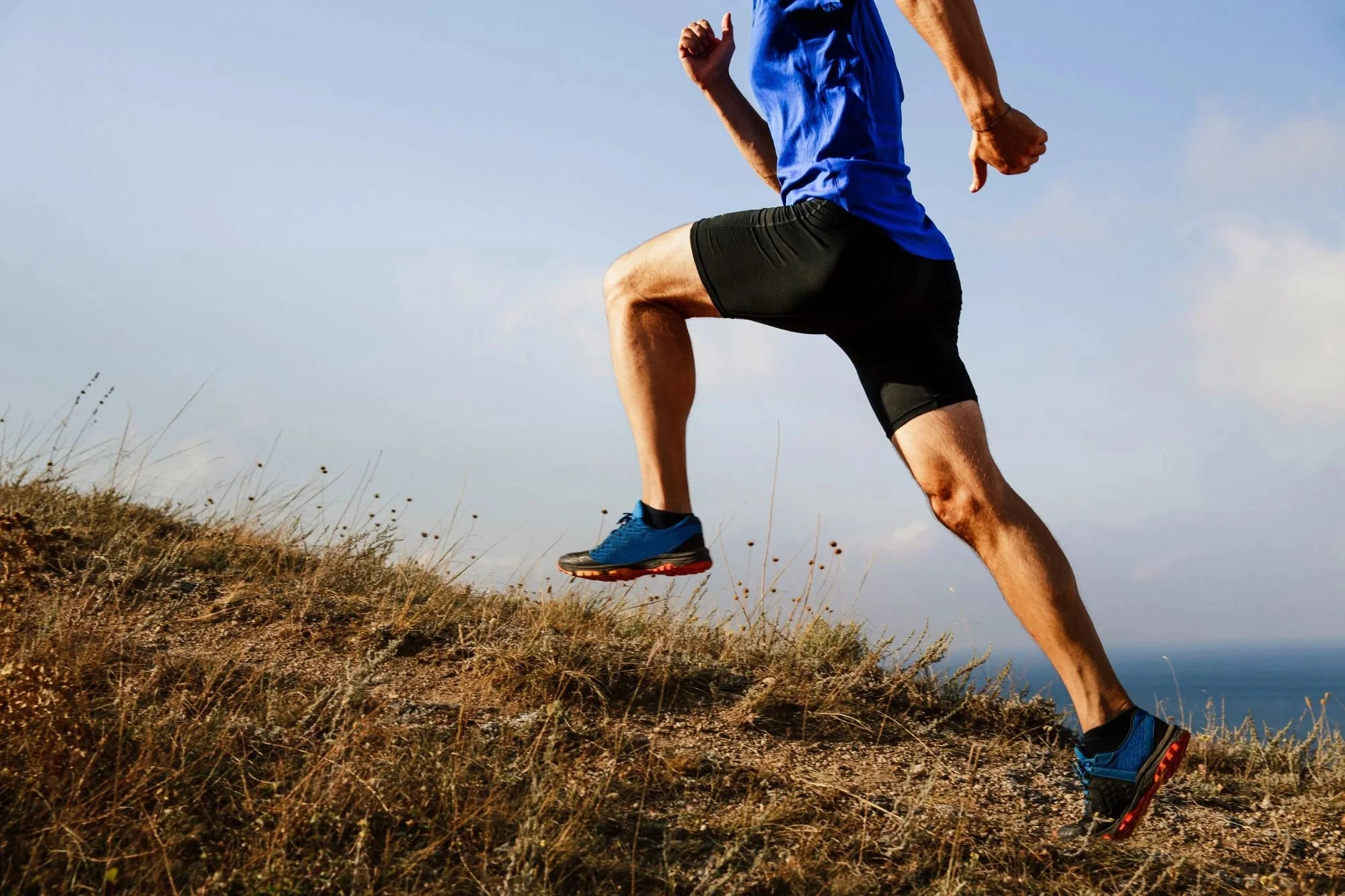 A man running uphill pain-free after abdominal acupuncture treatment