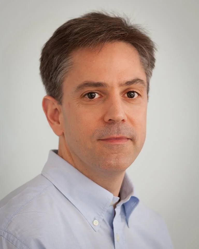 Dr. Ryan Licensed acupuncturist gazing softly into camera.