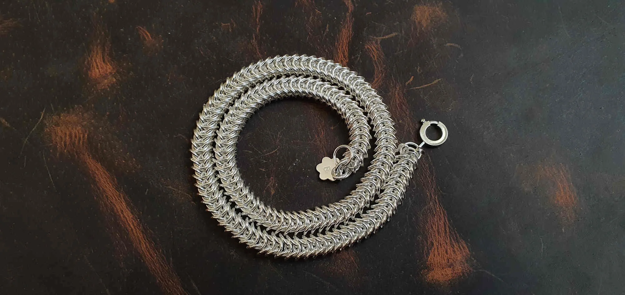 Dragon tail with daisy handmade sterling silver necklace - showing it a swirl