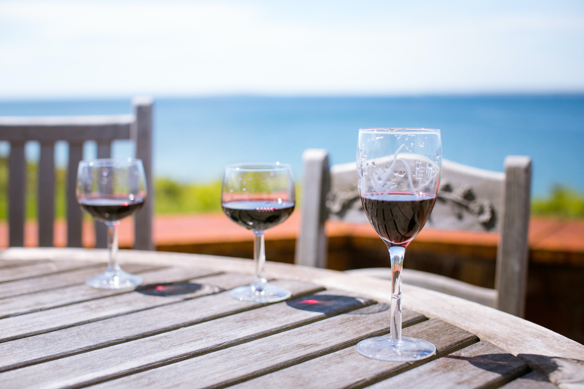 Wine glasses on a table overlooking the ocean.jpg