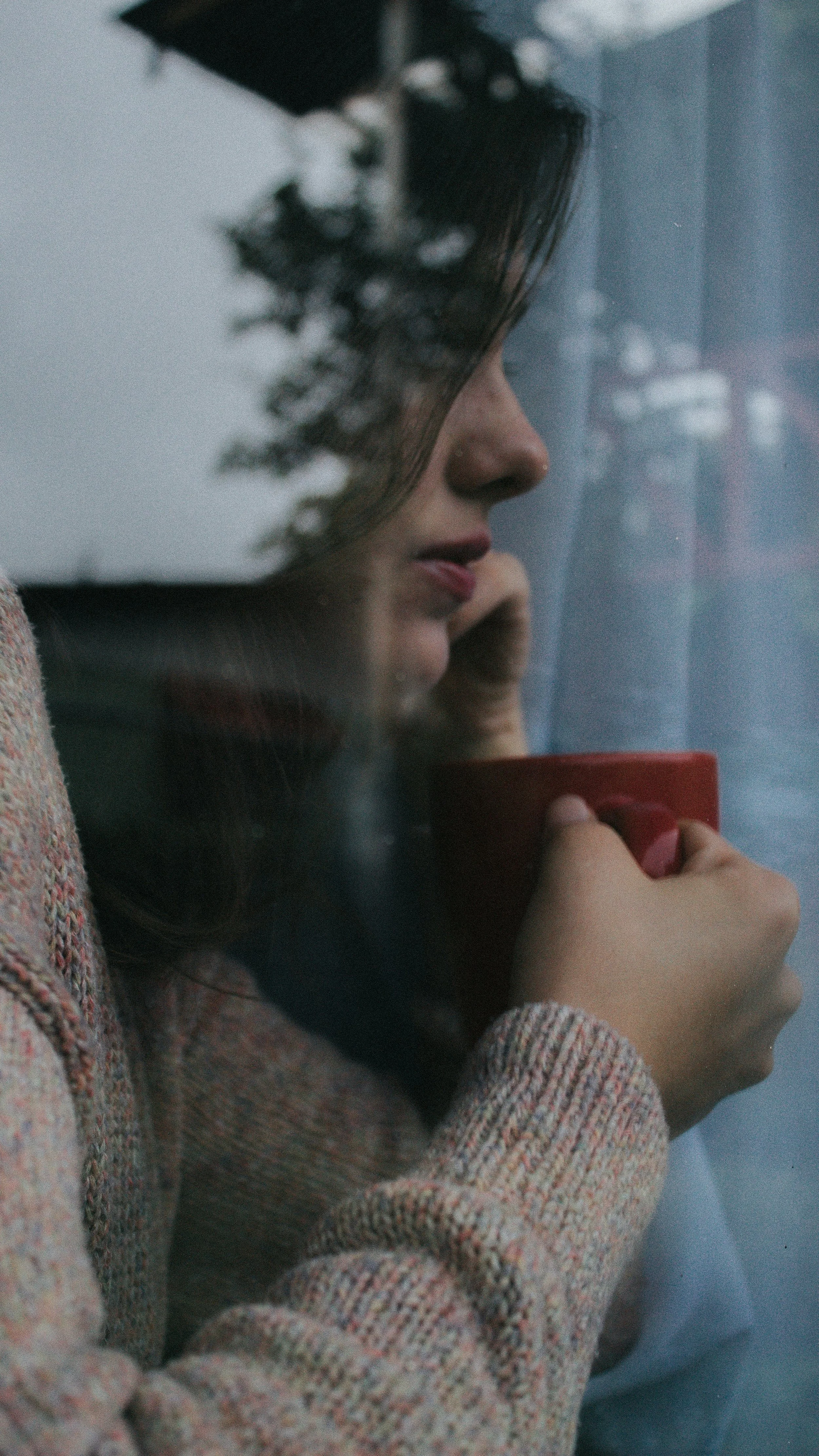 Person sitting quietly on Mother’s Day, reflecting on complicated emotions